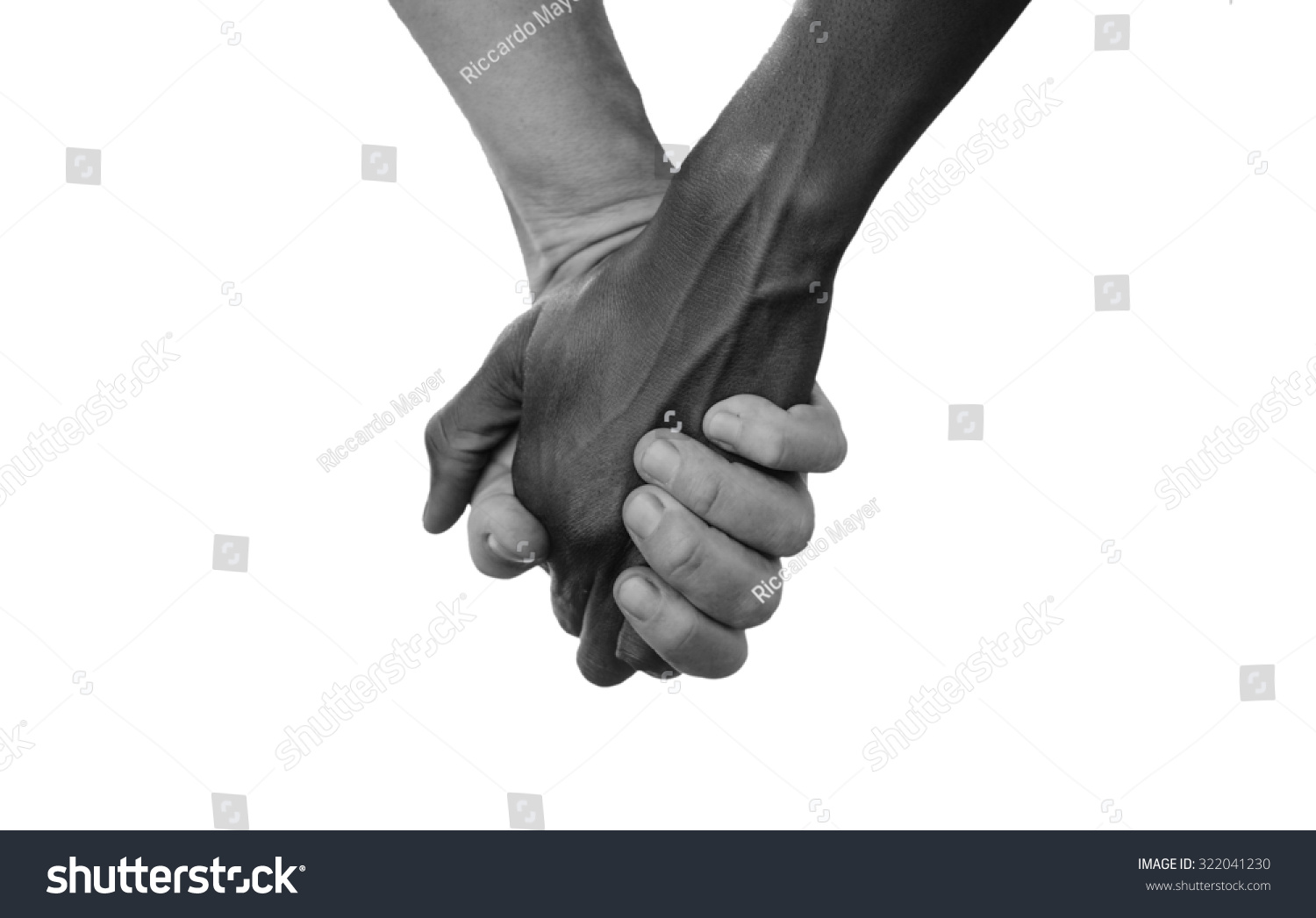 Black and White Hold Hands for Africa Union Peace Love. A beautiful shot with lots of possible background symbols. No to Racism! White woman holds hands with a little native African girl, in Mali.  #322041230