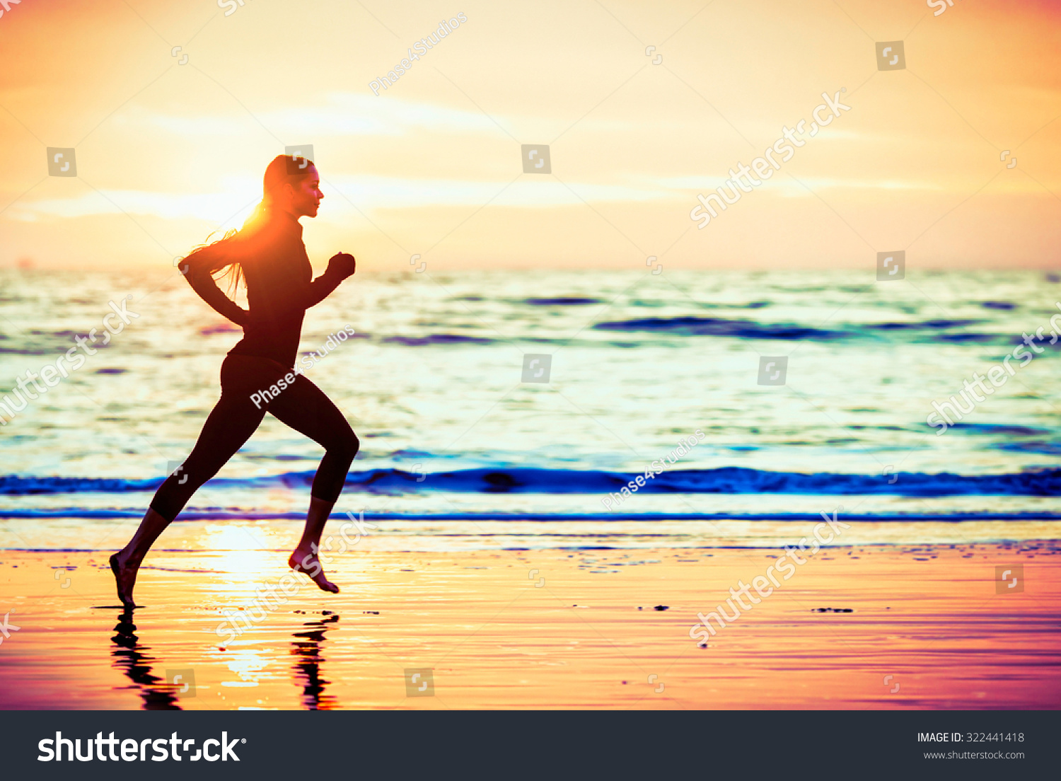 Woman running on the beach at sunset - male version in portfolio #322441418