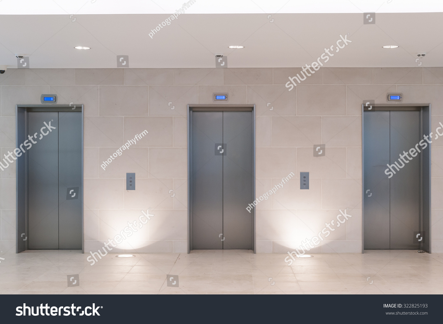 Three lift doors in office building #322825193