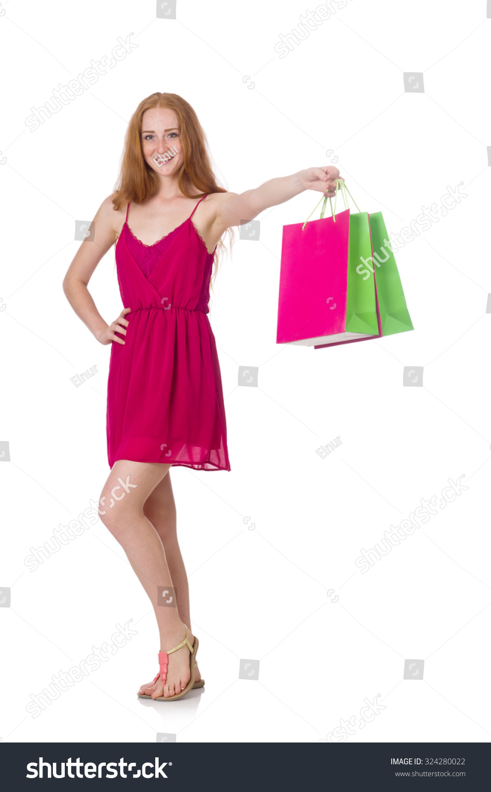 Woman with shopping bags isolated on white #324280022