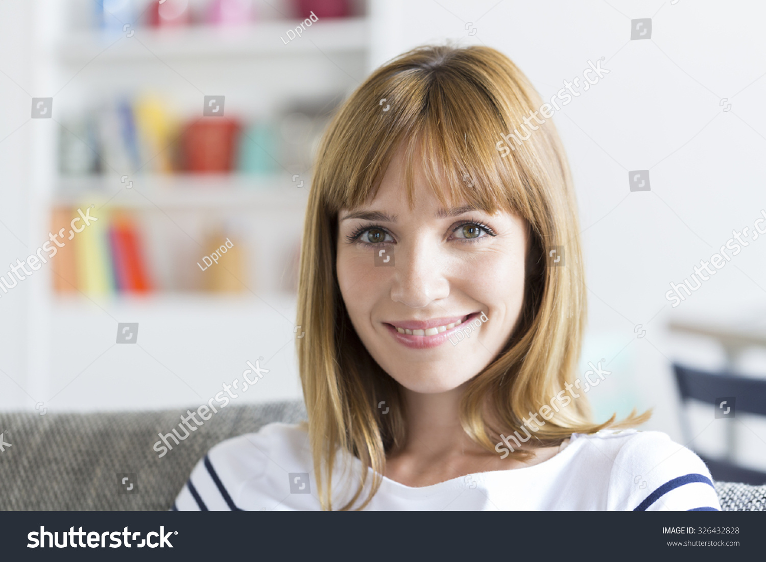 Portrait of cute thirty year old  woman in white modern apartment. Face camera #326432828