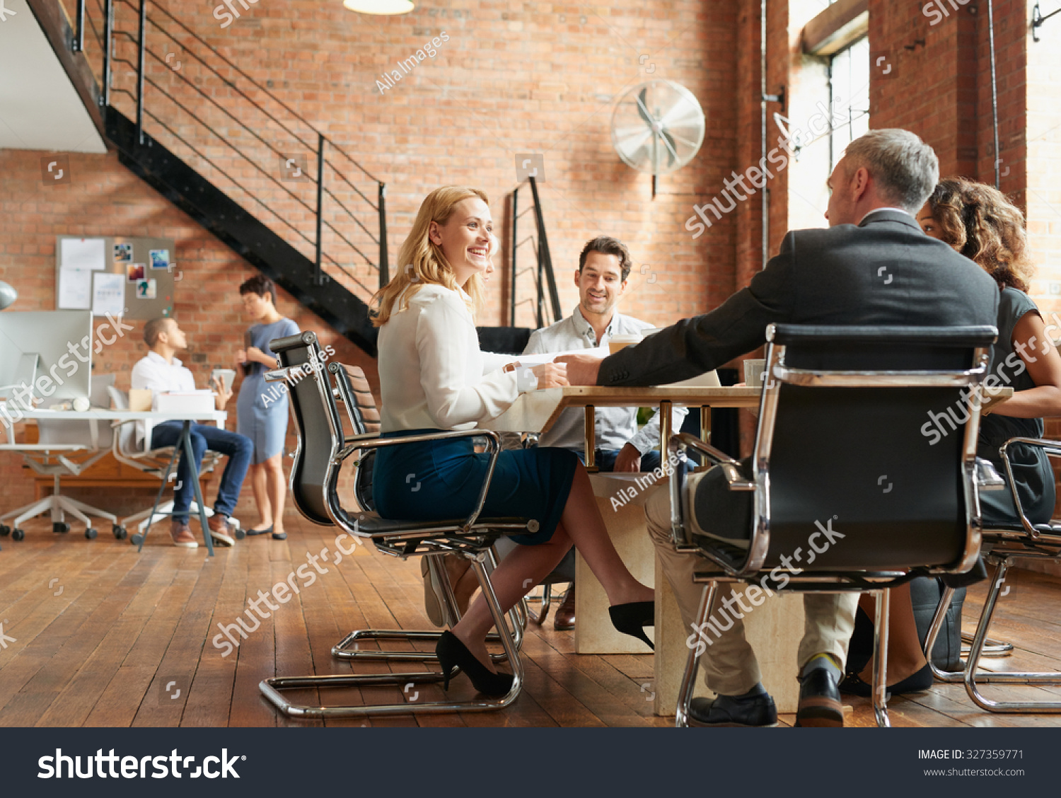 Exciting boardroom meeting with business people in trendy office space #327359771