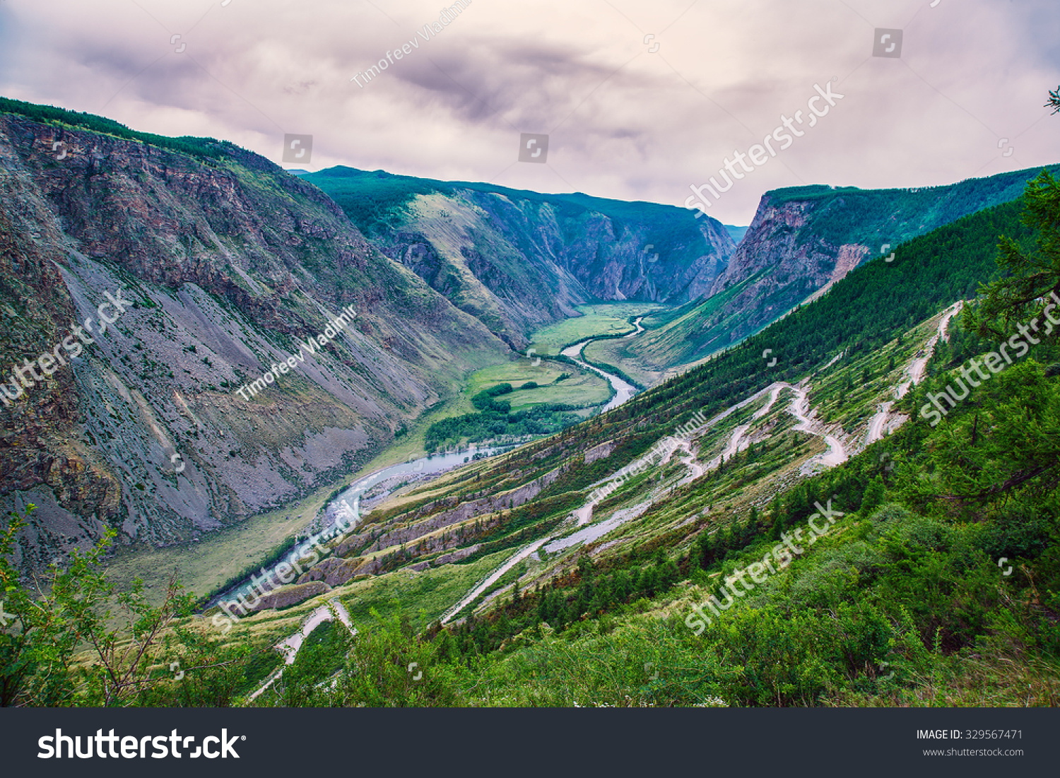 pass in a mountain valley with a river #329567471