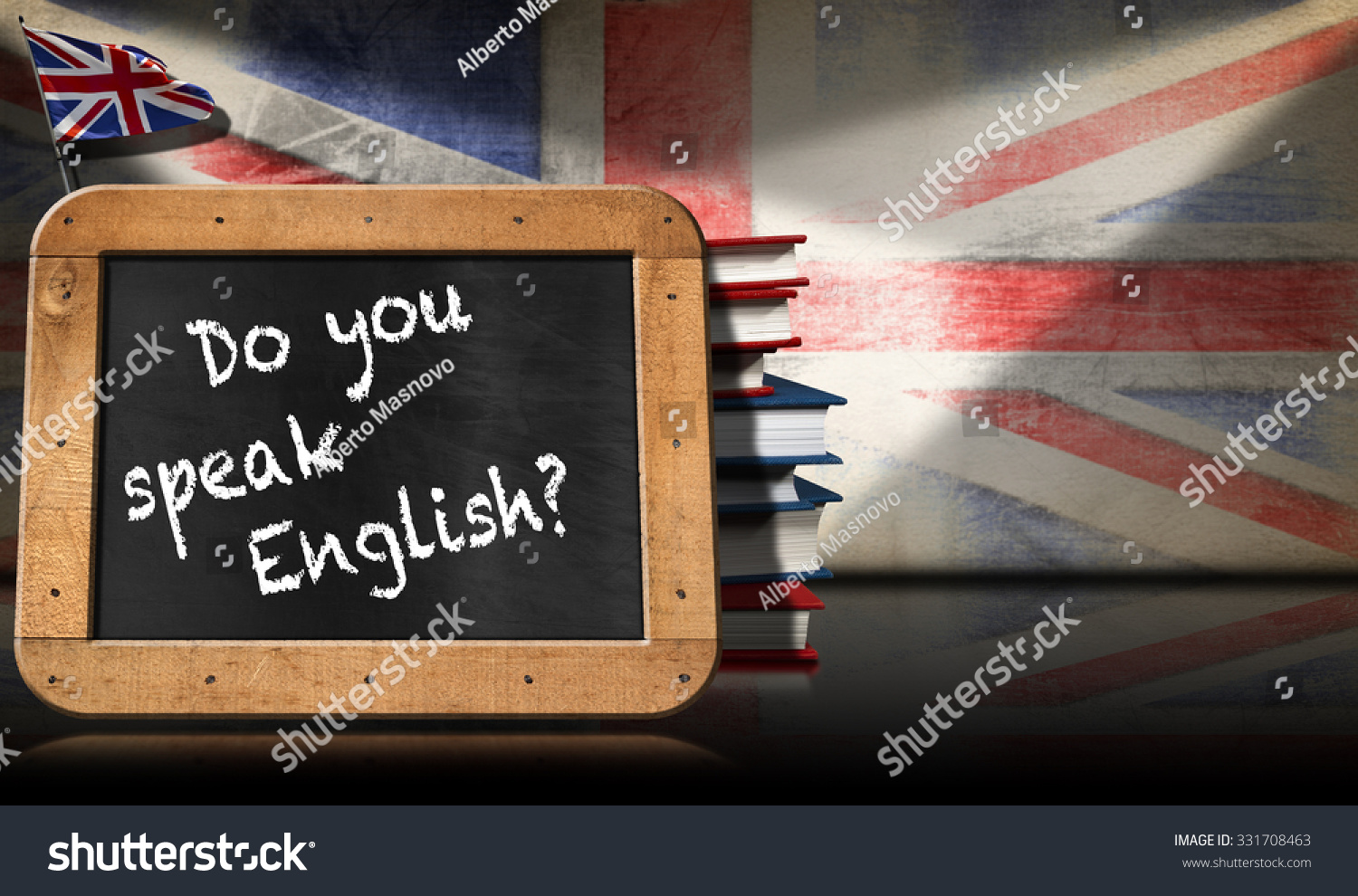 Do You Speak English - Blackboard and Books / Blackboard with wooden frame and text Do you speak english? A stack of books on a wall with Uk flag #331708463