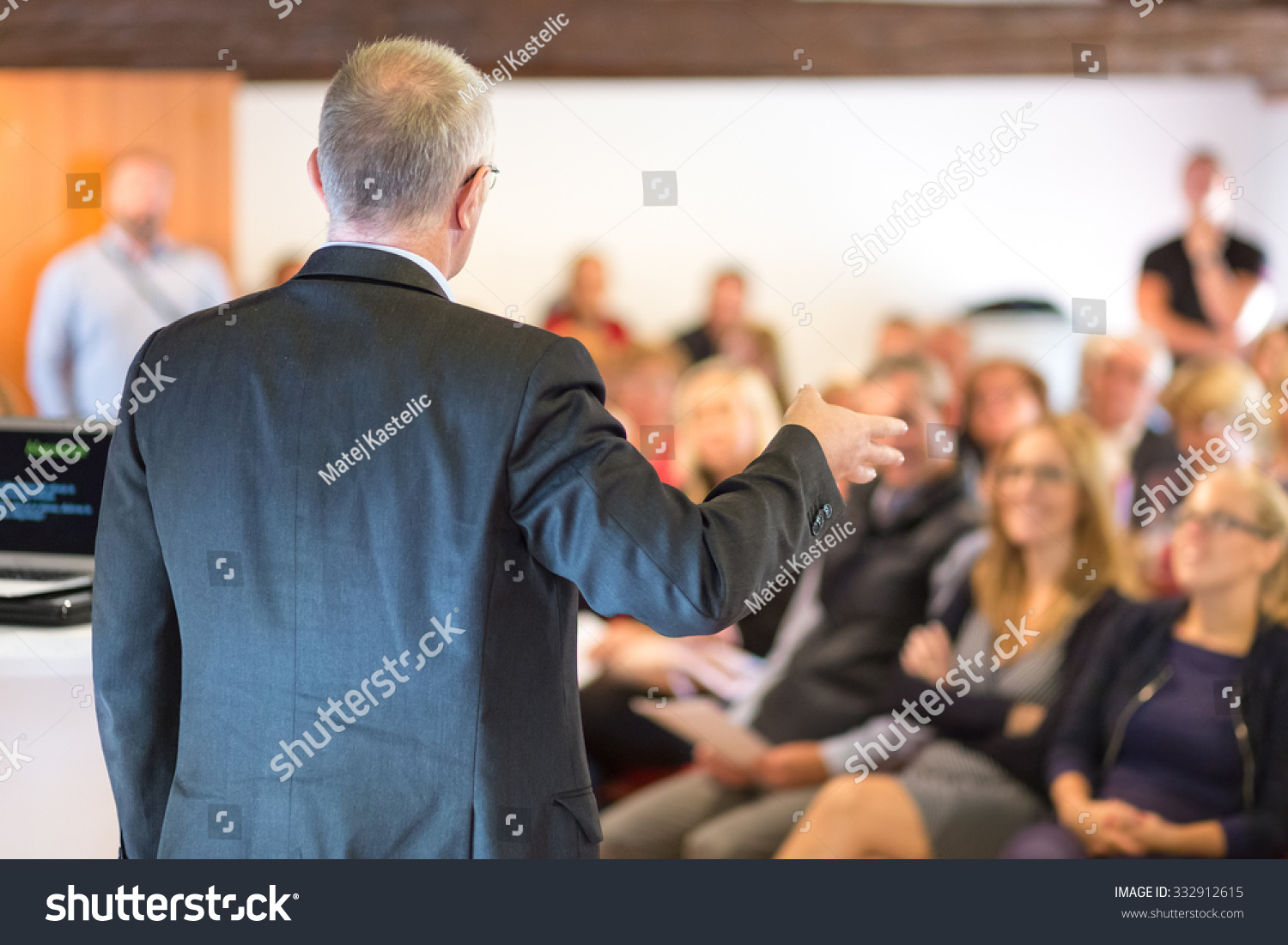 Business man leading a business workshop. Corporate executive delivering a presentation to his colleagues during meeting or in-house business training. Business and entrepreneurship concept. #332912615
