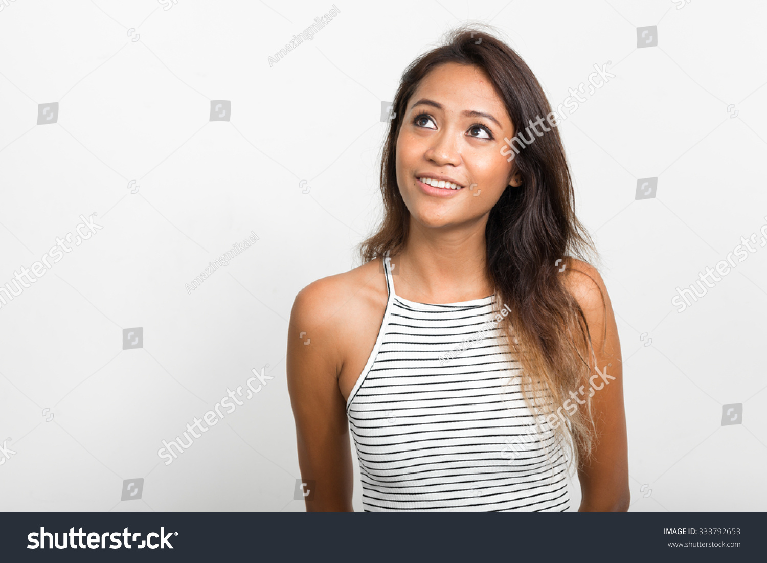 Portrait of beautiful Asian woman daydreaming and looking up #333792653