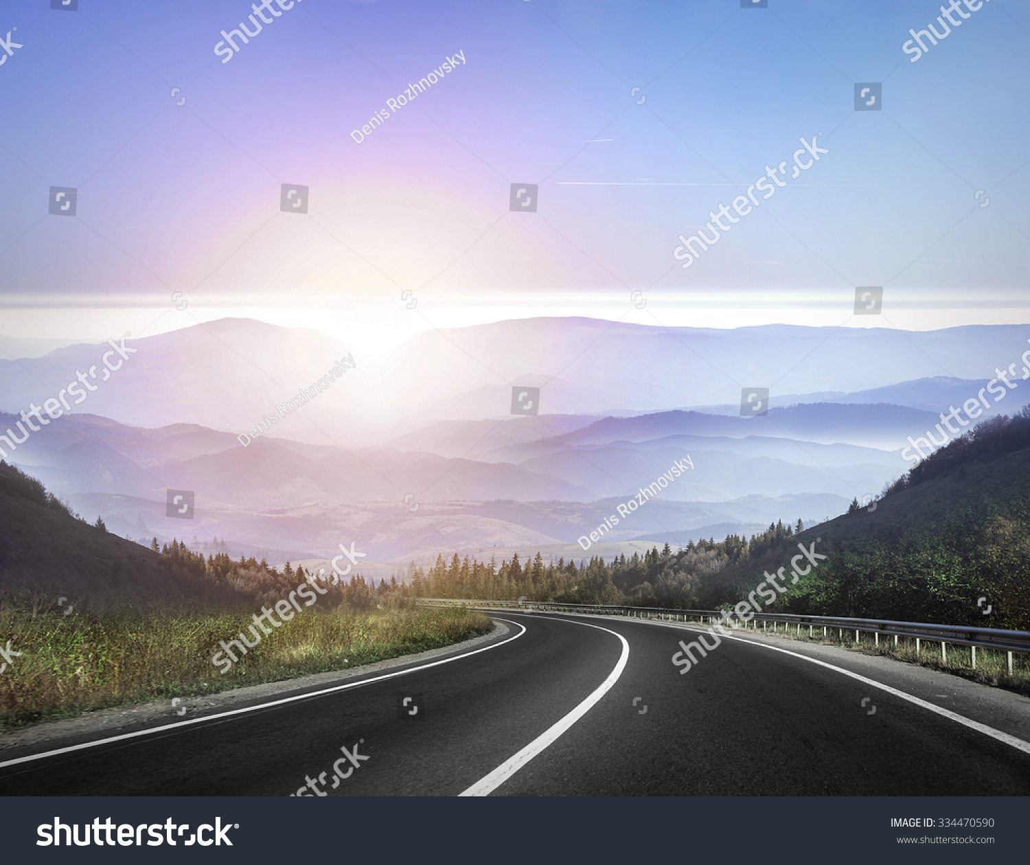 Highway road against mountains and a sky at the sunrise or sunset. #334470590