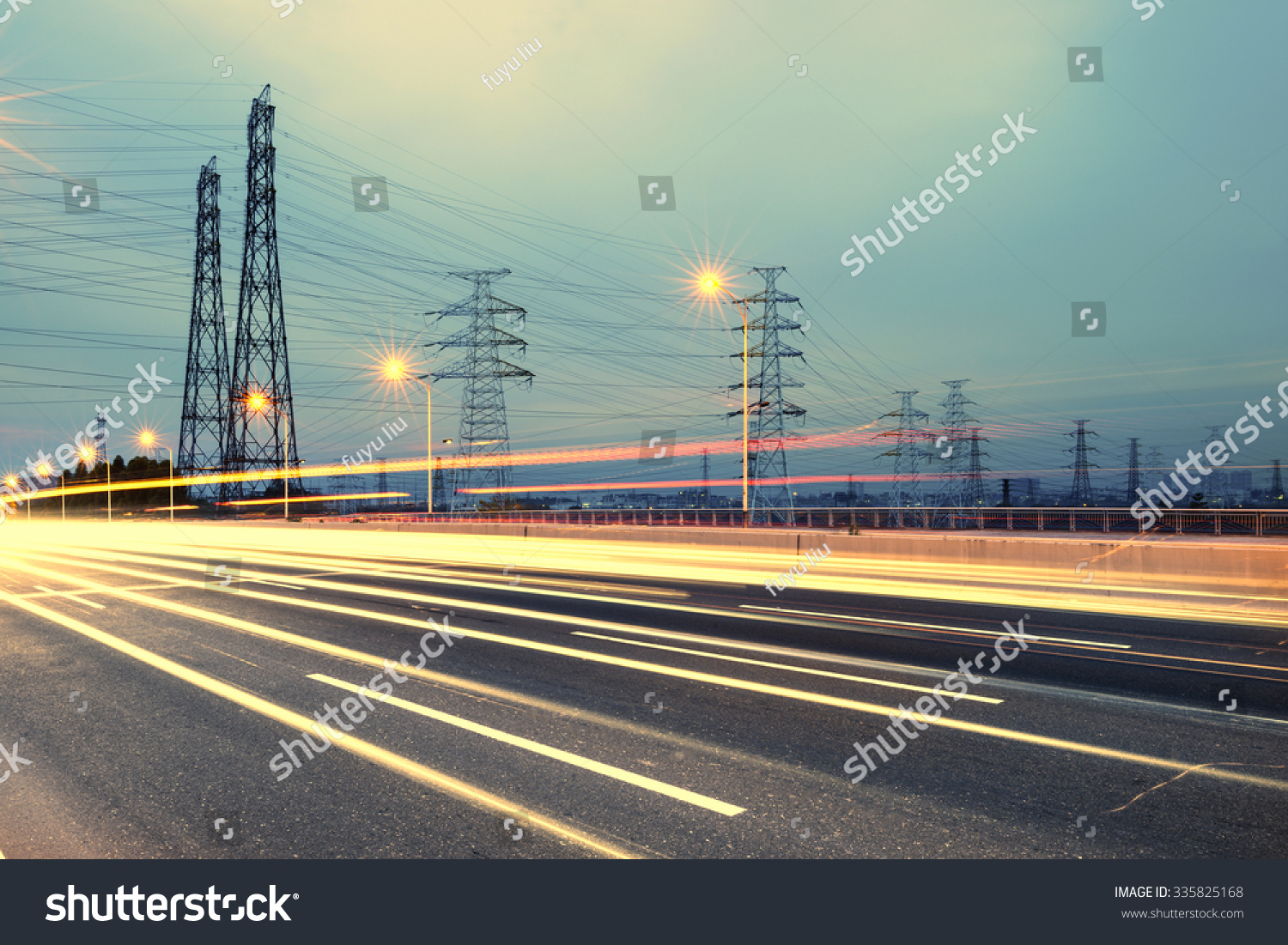 high voltage post.High-voltage tower sky background,besides the highway #335825168
