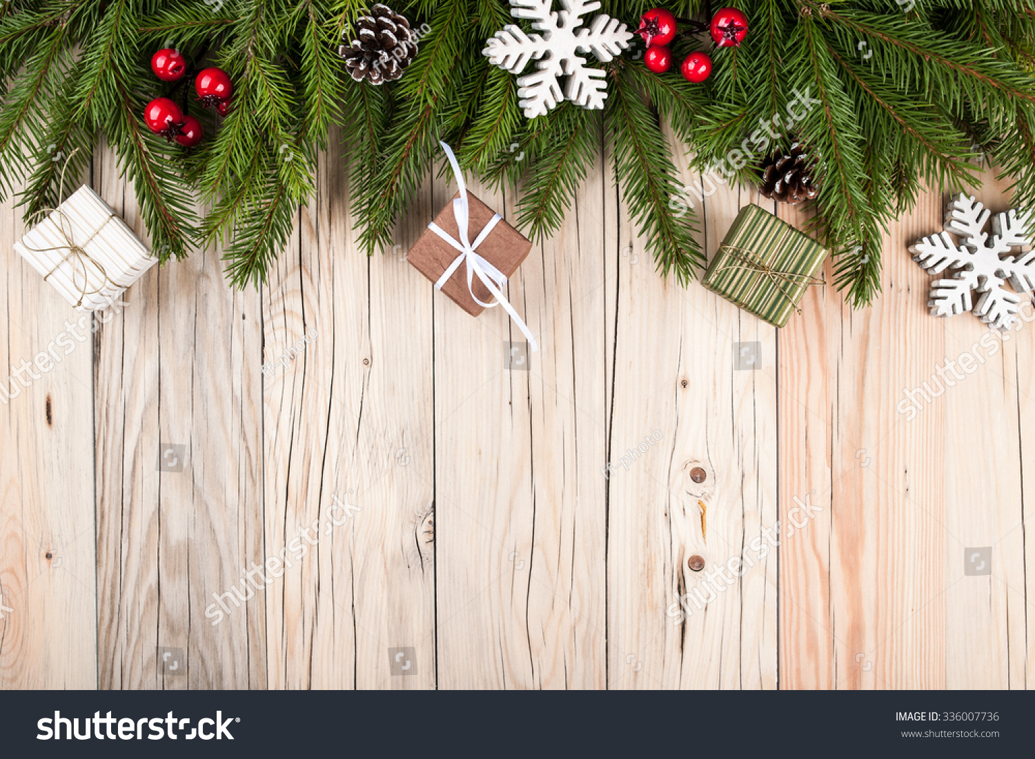 Fir tree with christmas decorations and gift boxes on wooden background #336007736