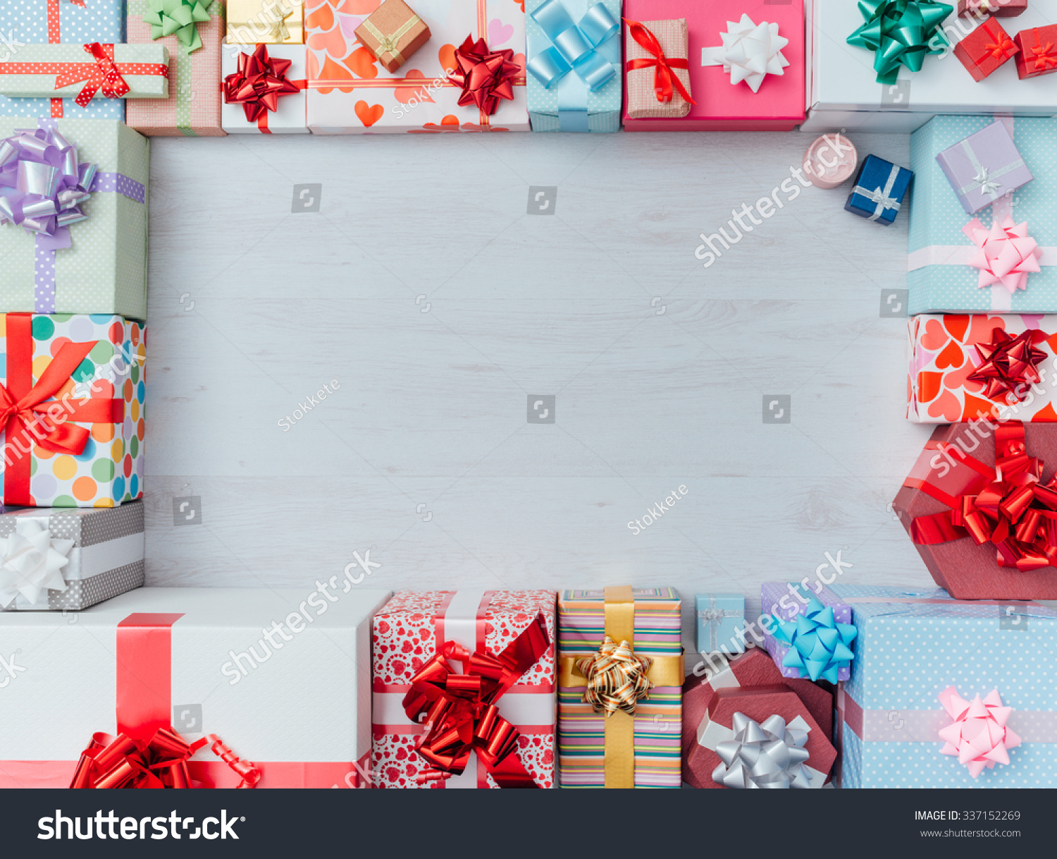 Colorful gift boxes framing a blank copy space on a desktop, top view, Christmas and celebrations concept #337152269