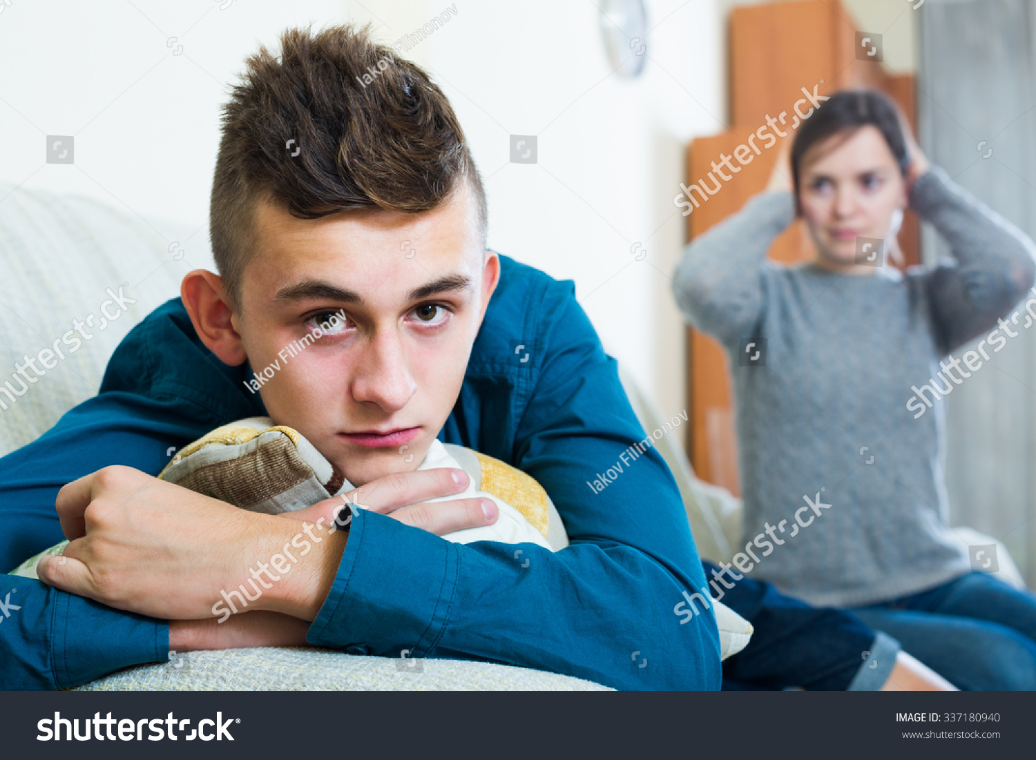 Frustrated mother scolding teenager son at home. focus on american boy #337180940