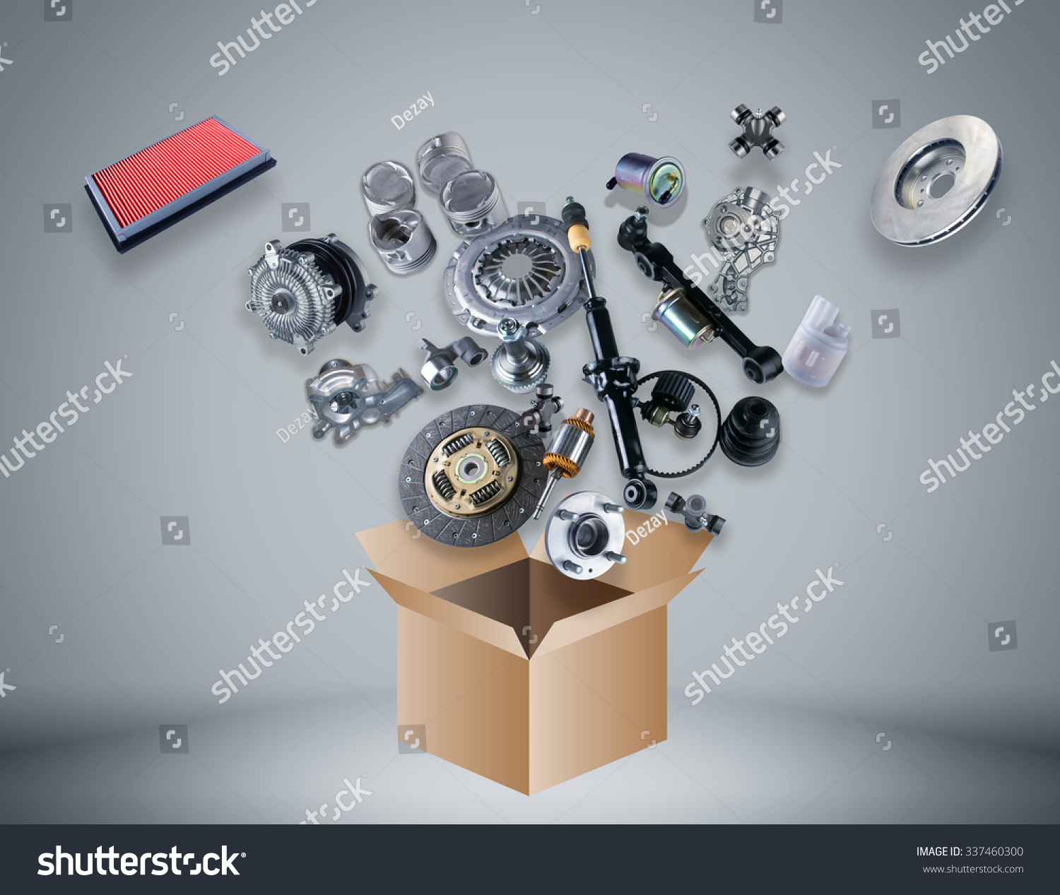 Many spare parts flying out of the box gray background. Isolated auto spare parts on gray background. Auto spare parts for passenger car, OEM. Isolated absorber, gasket, filters, parts for chassis. #337460300