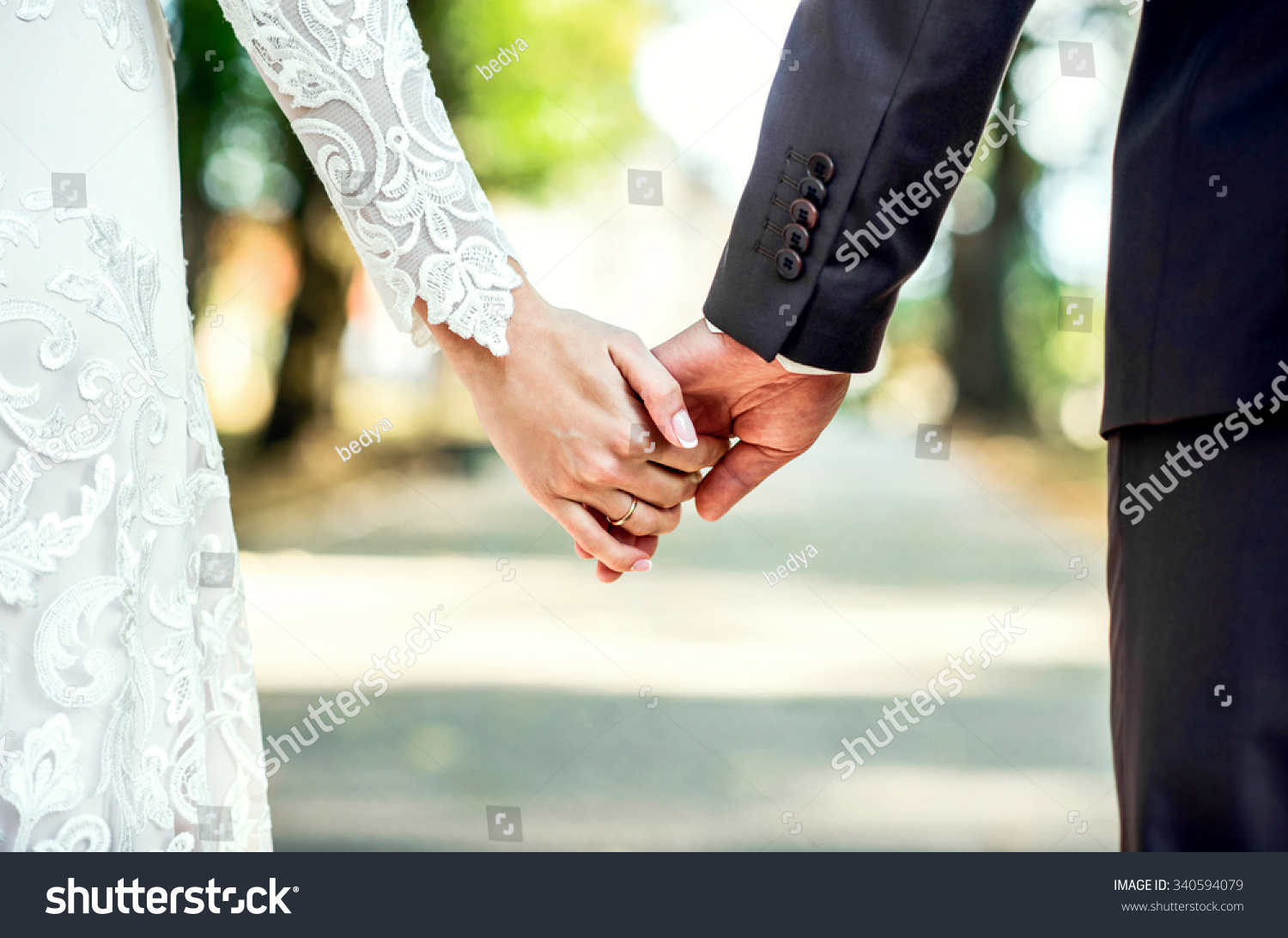 Closeup view of married couple holding hands  #340594079
