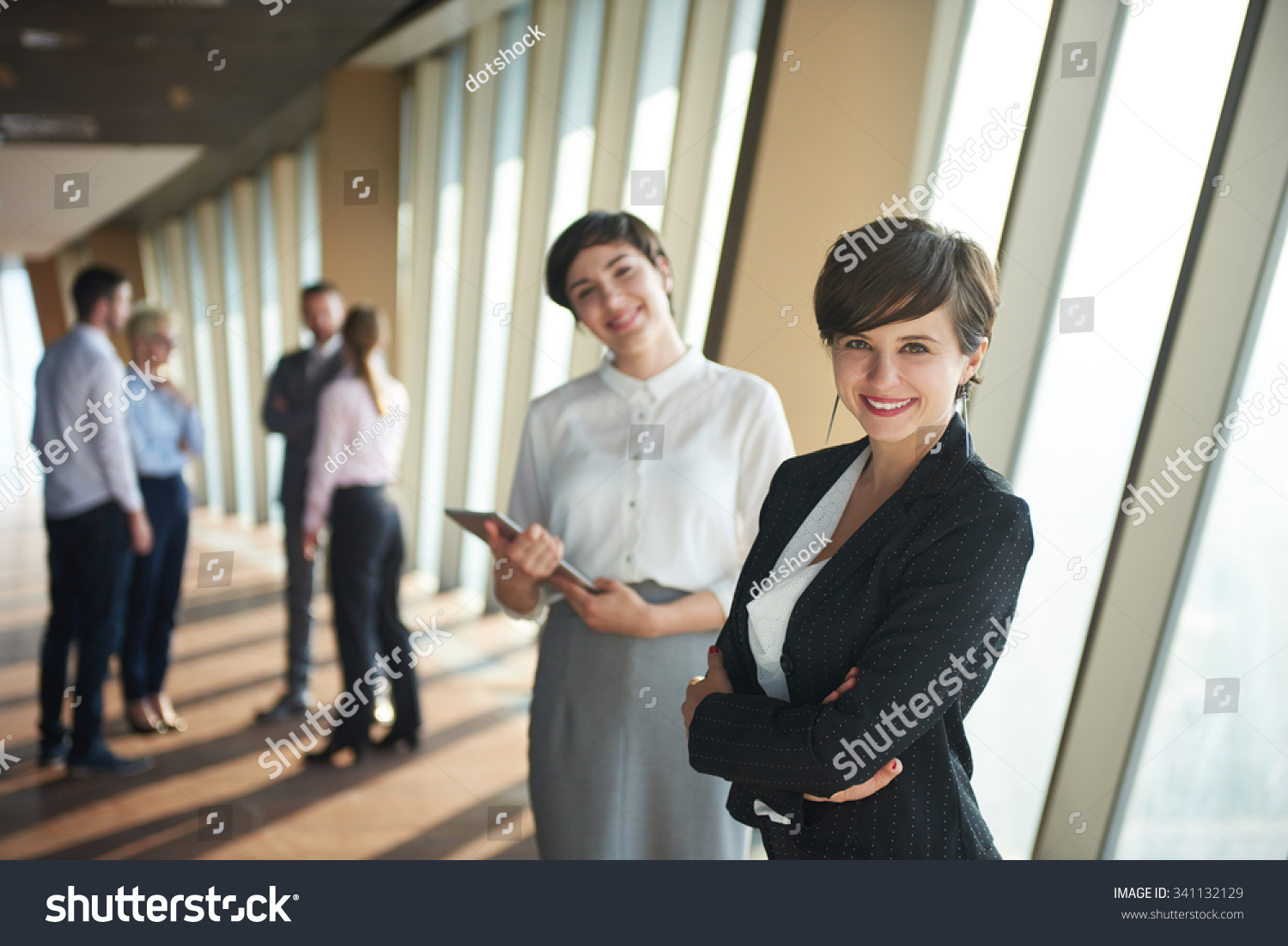 business people group,  females as team leaders standing together  in modern bright office interior #341132129