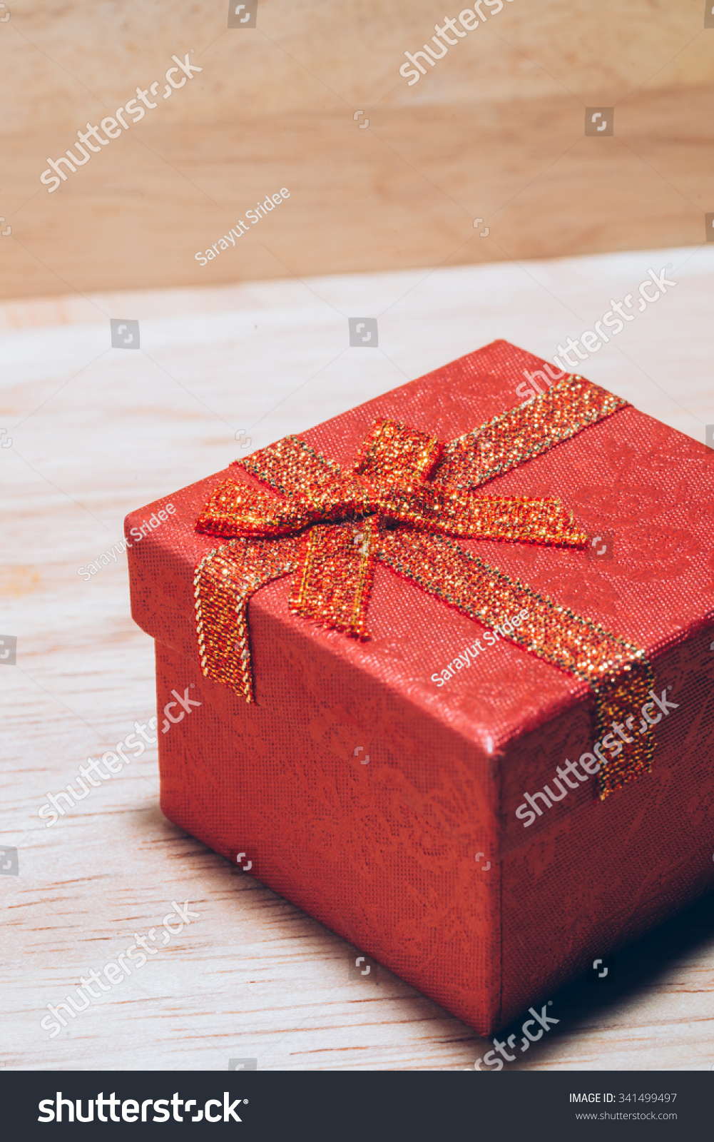 Christmas gift red box on wooden background #341499497