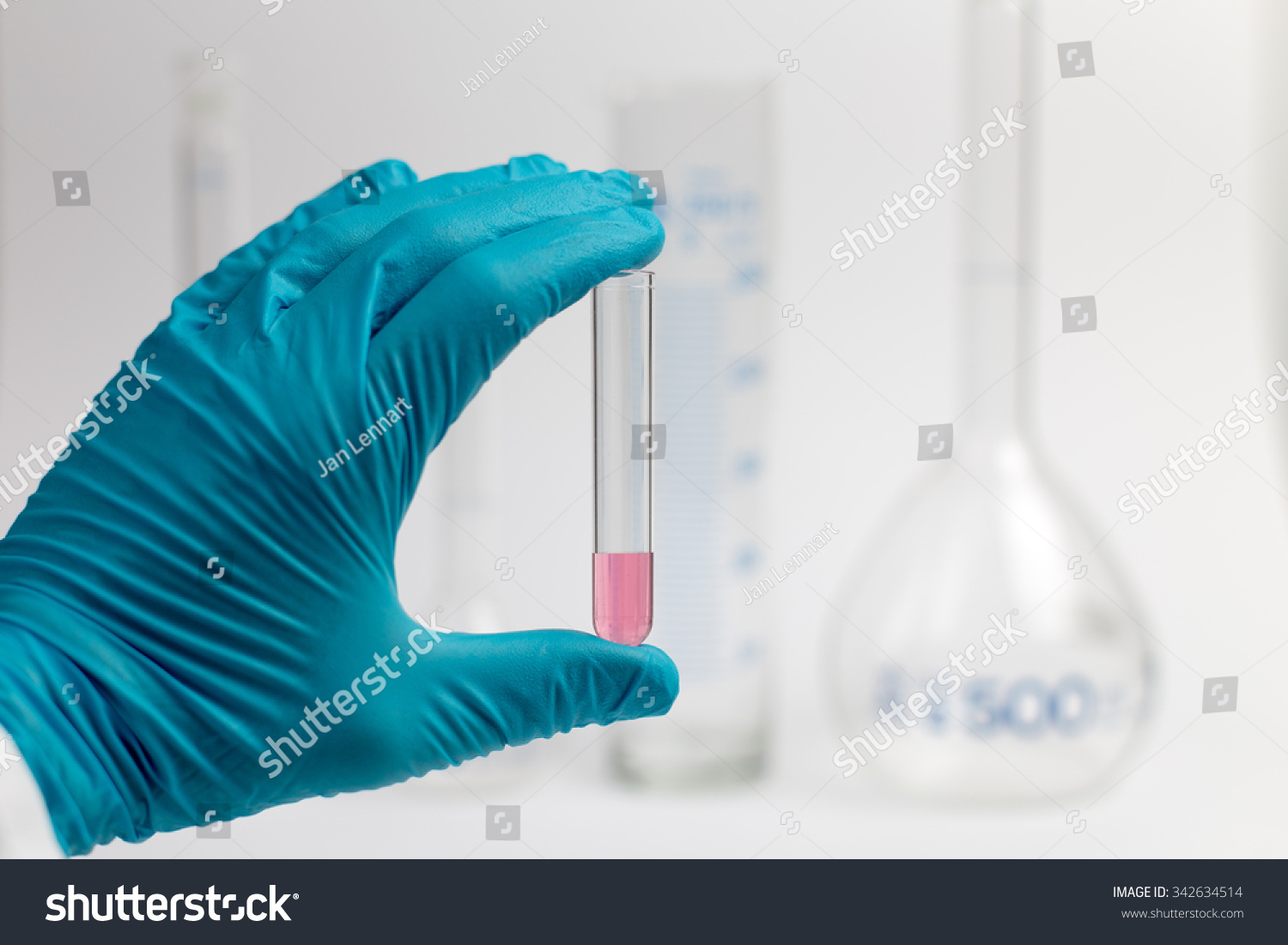 Researcher holding a test tube with medium in her hand #342634514