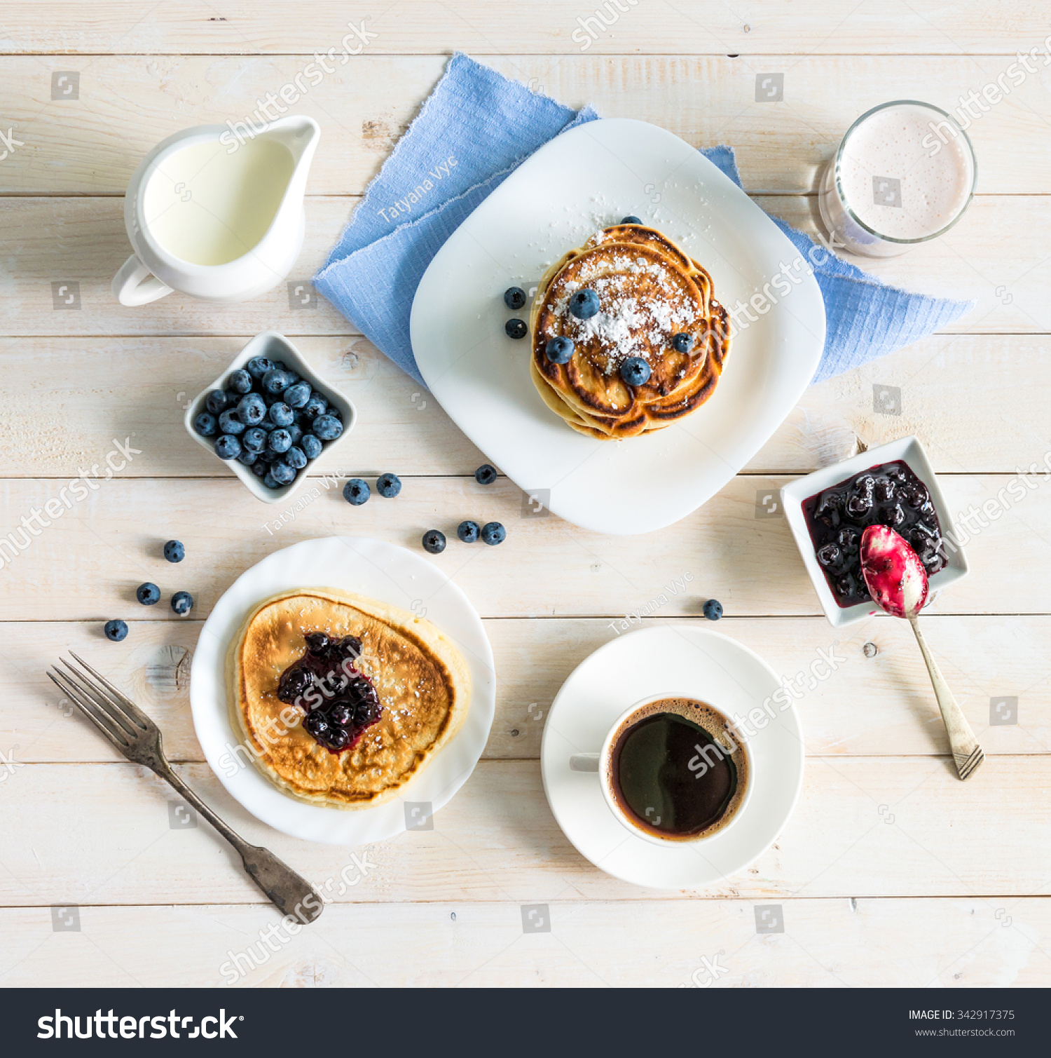 pancakes with blueberry and coffee on wooden background. top view #342917375