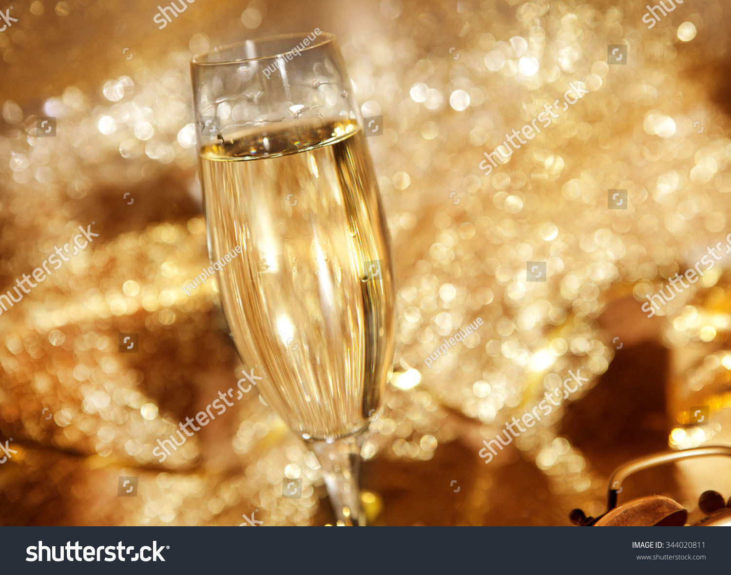 a glass with champagne in festive decoration #344020811