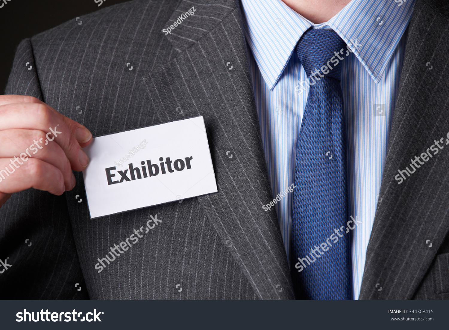 Businessman Attaching Exhibitor Badge To Jacket #344308415