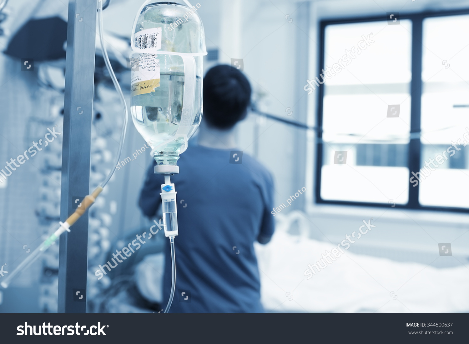 Physician works with critically ill patient in hospital #344500637