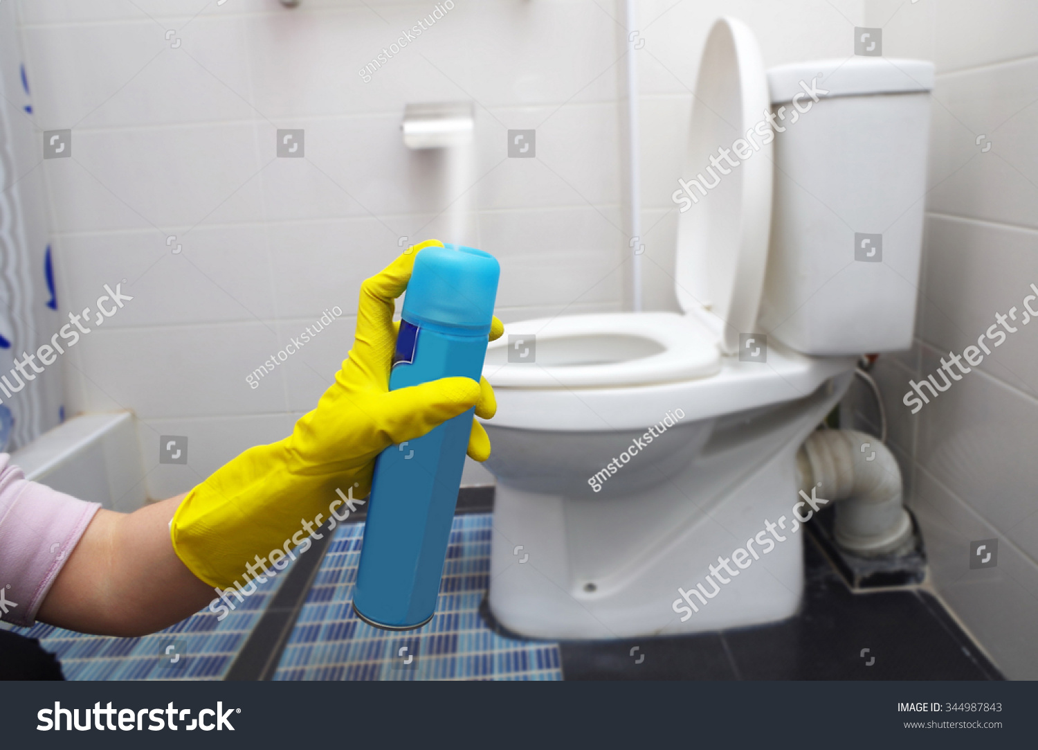 air freshner in hand in toilet #344987843