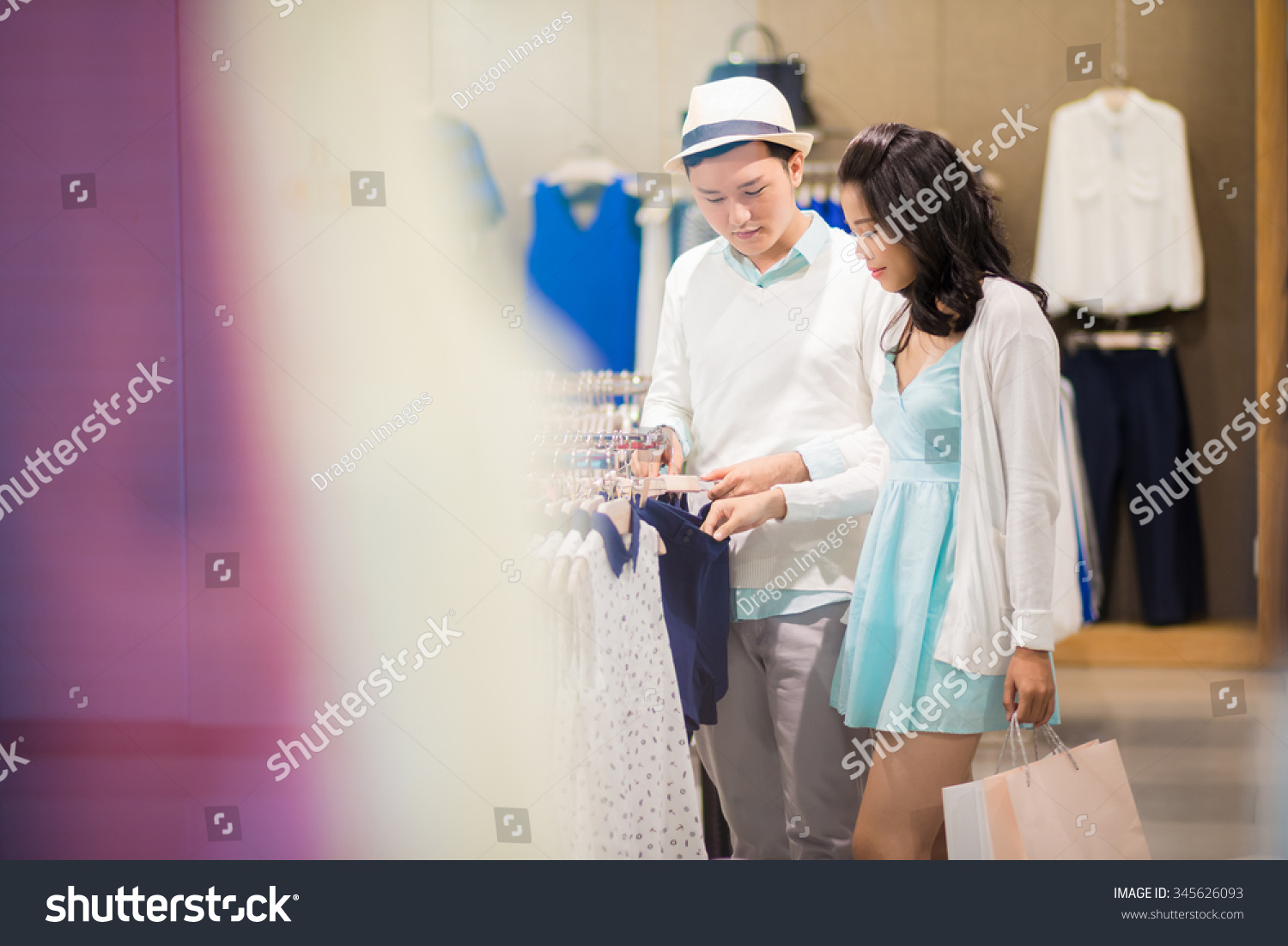 Boyfriend and girlfriend choosing clothes together #345626093