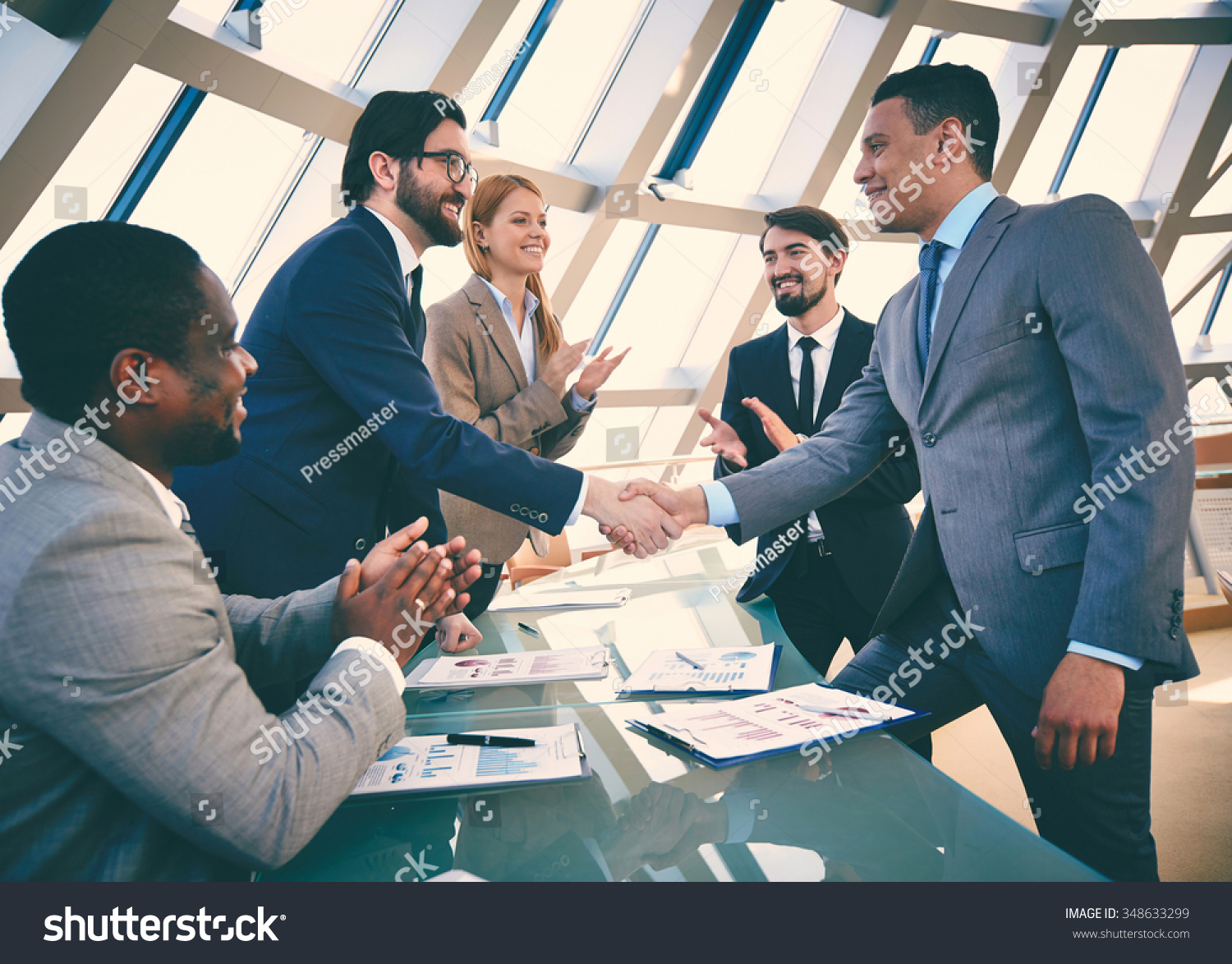 Business partners handshaking after signing contract #348633299