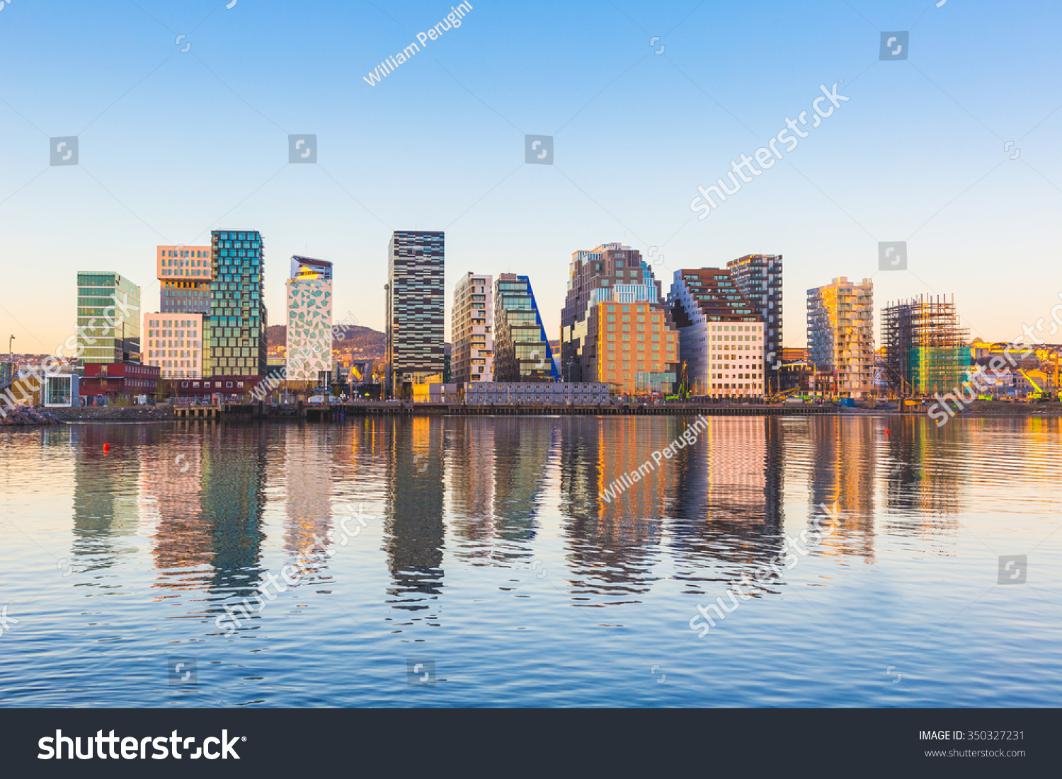Modern buildings in Oslo, Norway, with their reflection into the water. These are some of the new buildings in the neighbourhood of Bjorvika. Concepts of travel and architecture. #350327231