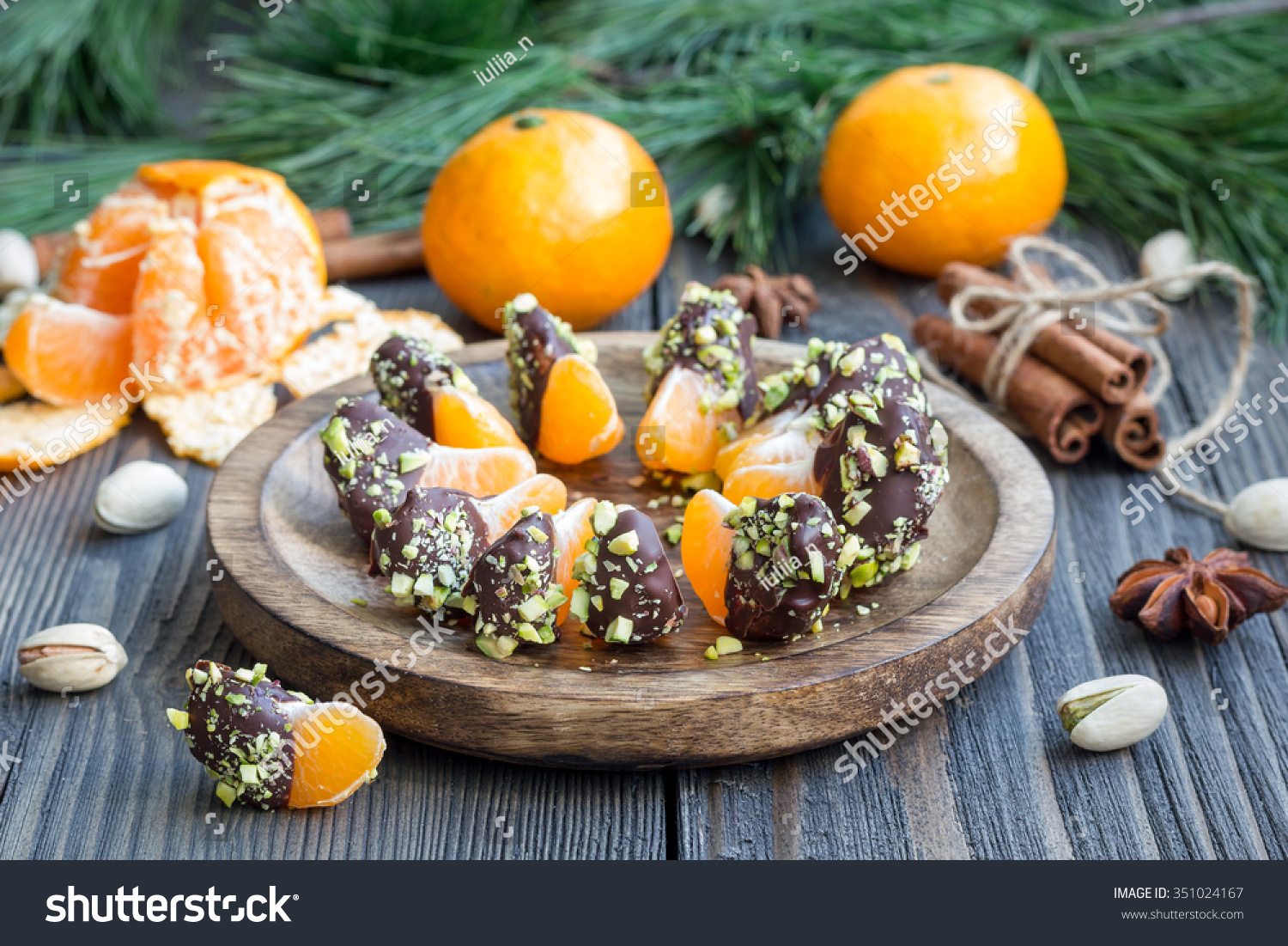 Mandarins covered with chocolate and pistachio #351024167