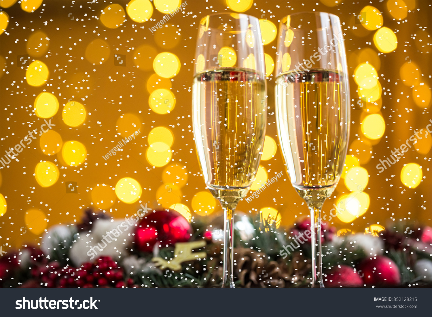 Two champagne glass on christmas bokeh background with snow #352128215