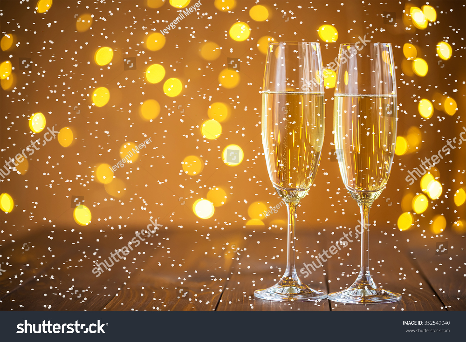 Two champagne glass on christmas bokeh background with snow #352549040