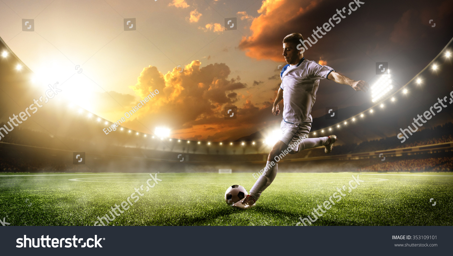 Soccer player in action on sunset stadium background #353109101