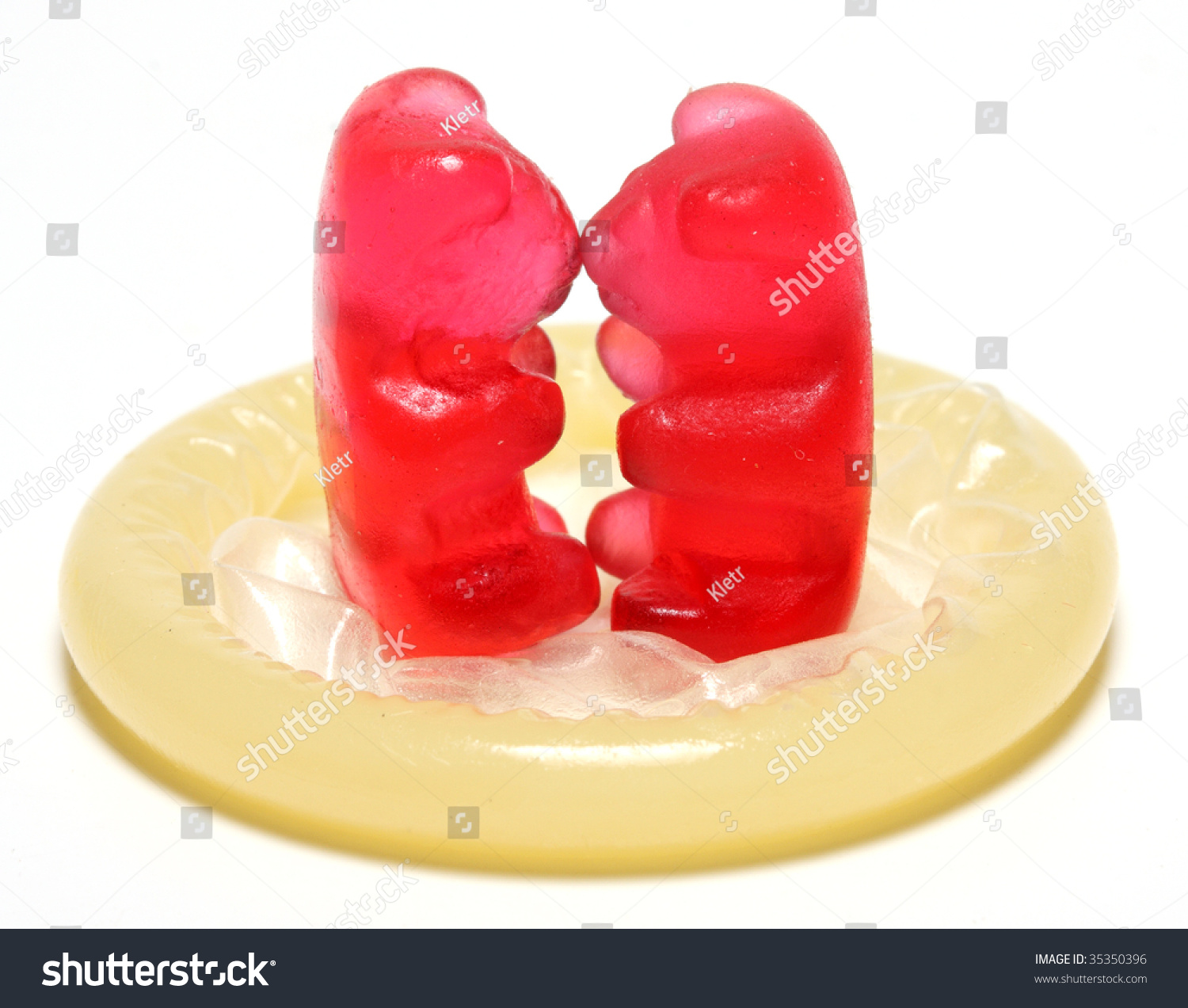 Loving red jelly bears couple on a condom - conceptual image - on white background #35350396