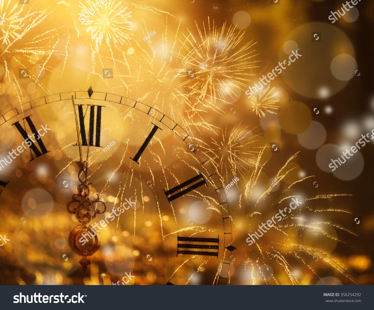 New Year's at midnight - Old clock with fireworks and holiday lights #356254292