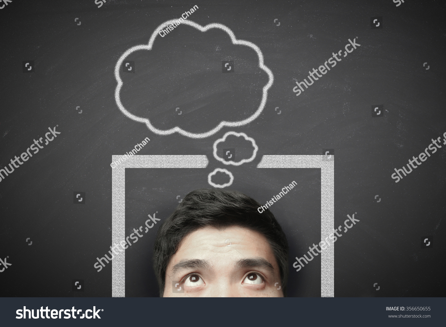 Man thinking outside the box with blackboard background. #356650655