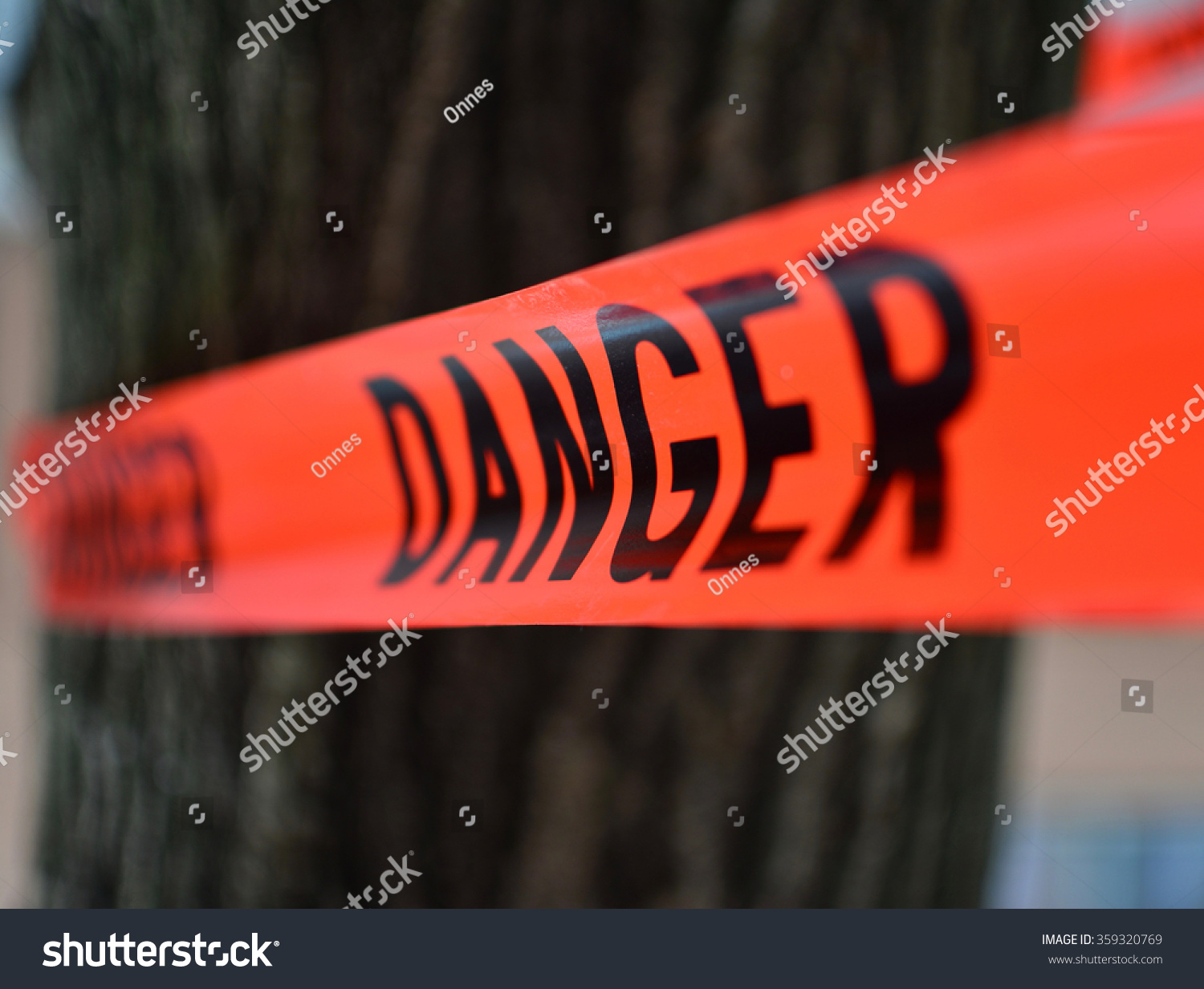 Danger Red Tape Warning in front of a tree/ Red Danger sign Tape #359320769