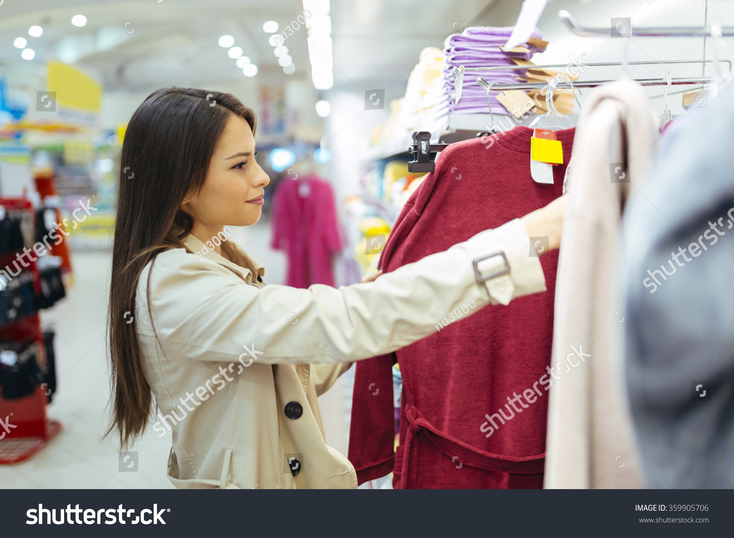 Beautiful woman glancing through clothes #359905706