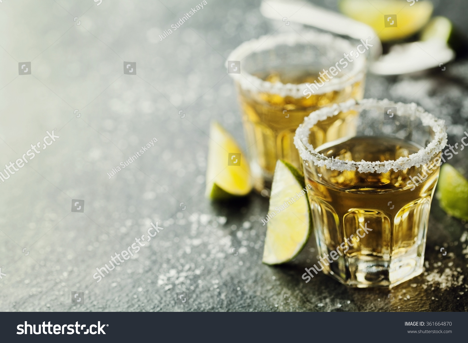 Tequila shot with lime and sea salt on black table, selective focus #361664870