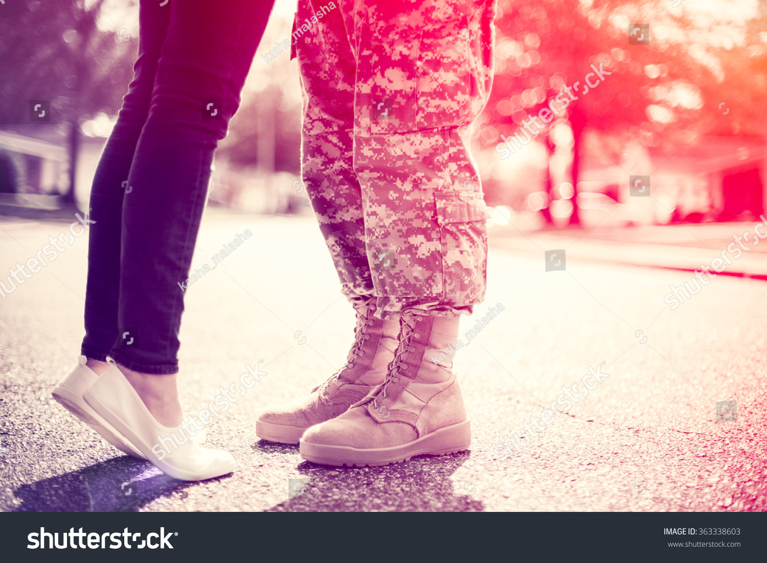 Young military couple kissing each other, homecoming concept, soft focus, cross process  toning applied, light leak in the corner #363338603