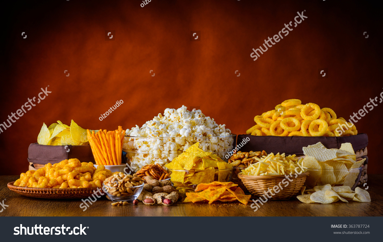 Different types of snacks, chips, nuts and popcorn in still life #363787724