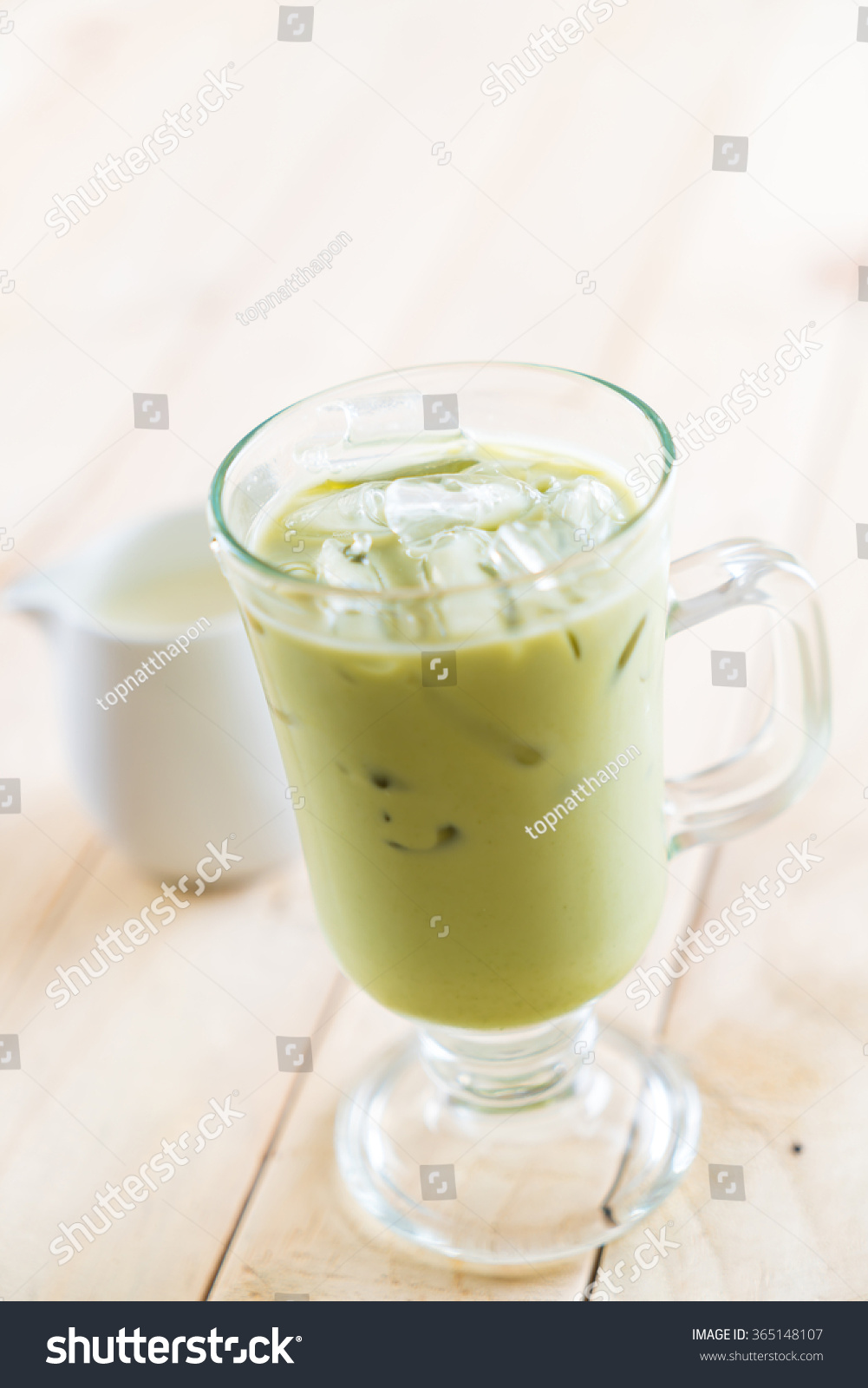 iced matcha latte on wood background #365148107