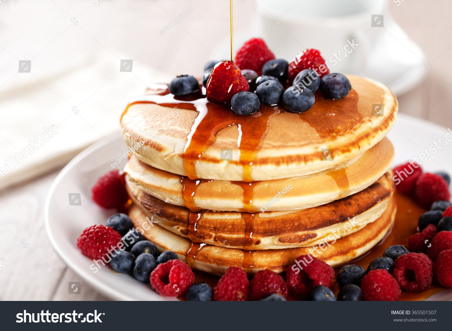 Pancakes with berries and maple syrup #365501507
