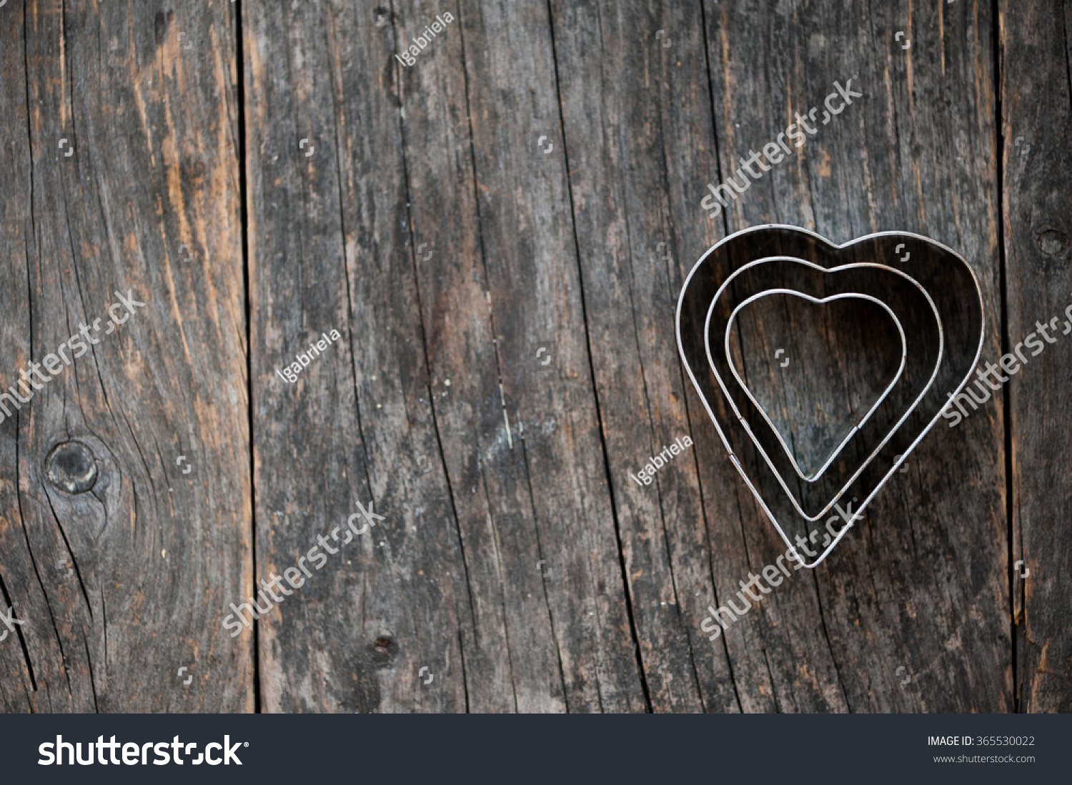 Heart shaped cookie cutter on a wooden background #365530022