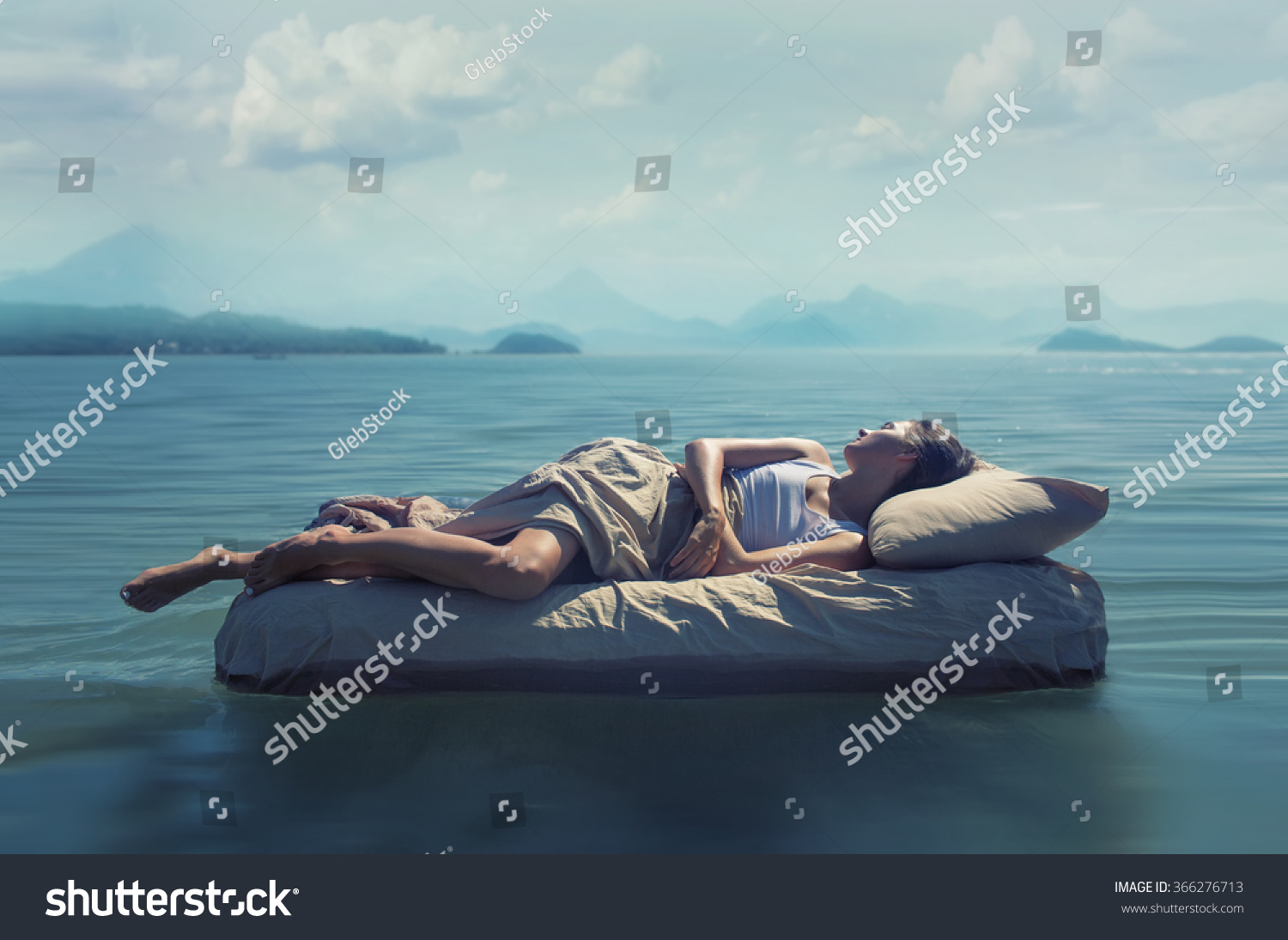 Sleeping woman lies on airbed in water. #366276713