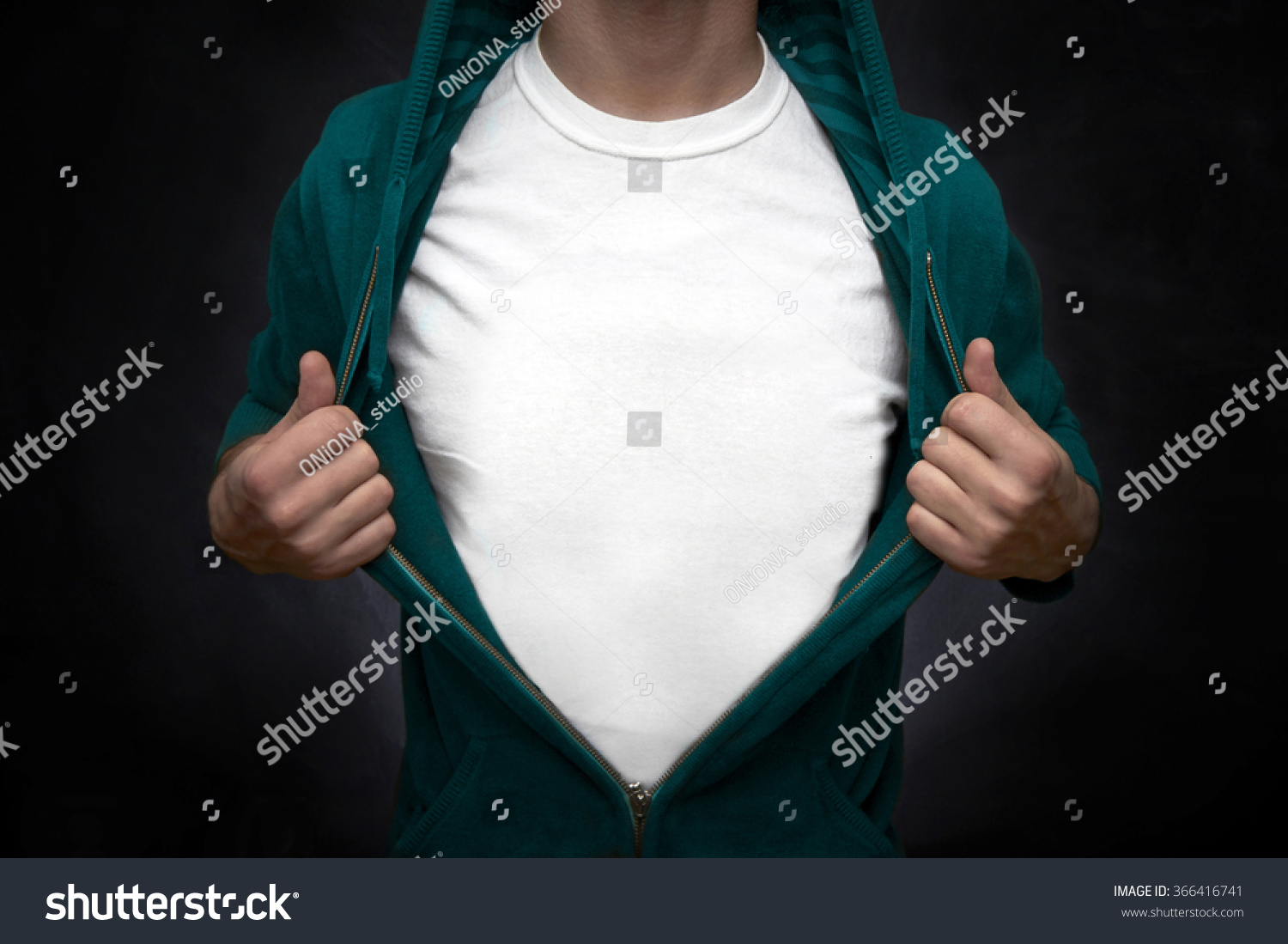 Hero pulling open turquoise blouse showing white t-shirt on blackboard background #366416741