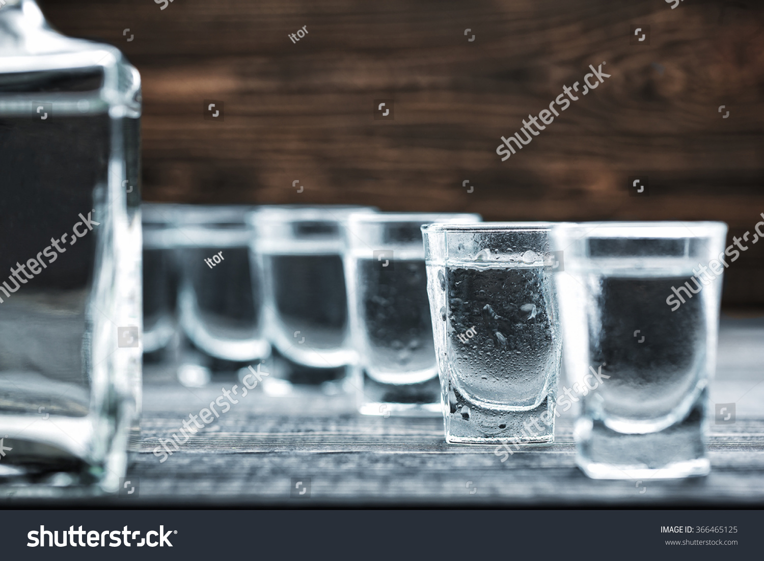  selectiv focus glasses of  cold vodka  on wooden table  #366465125