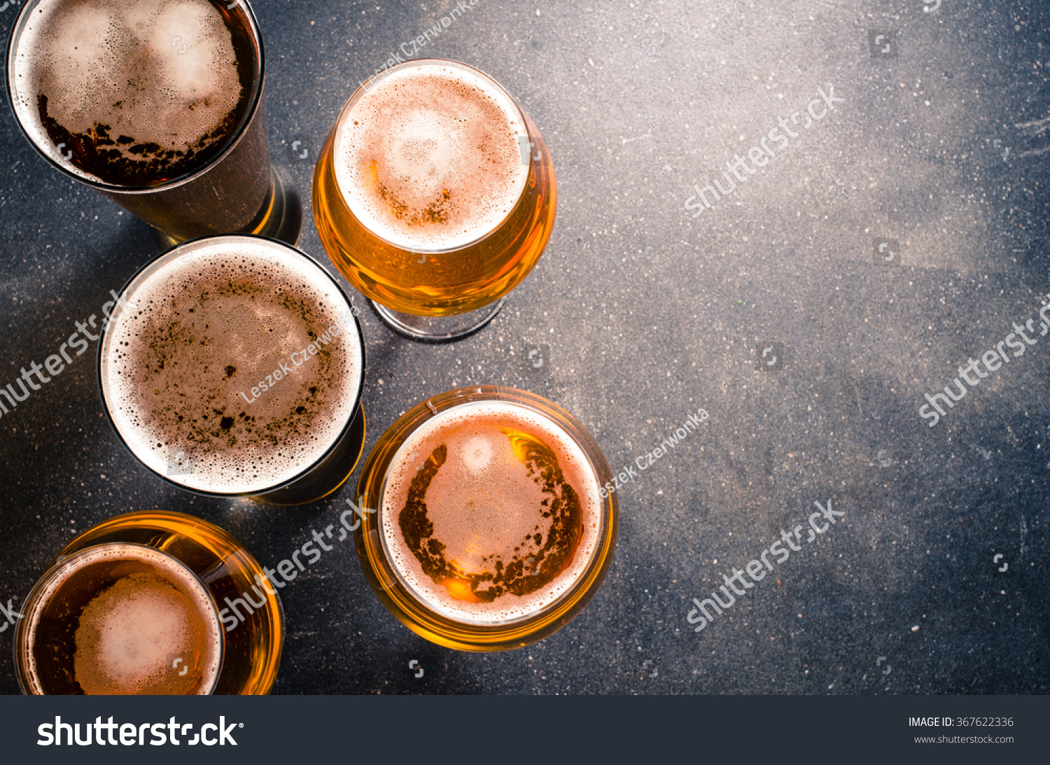 Beer glasses on dark table #367622336
