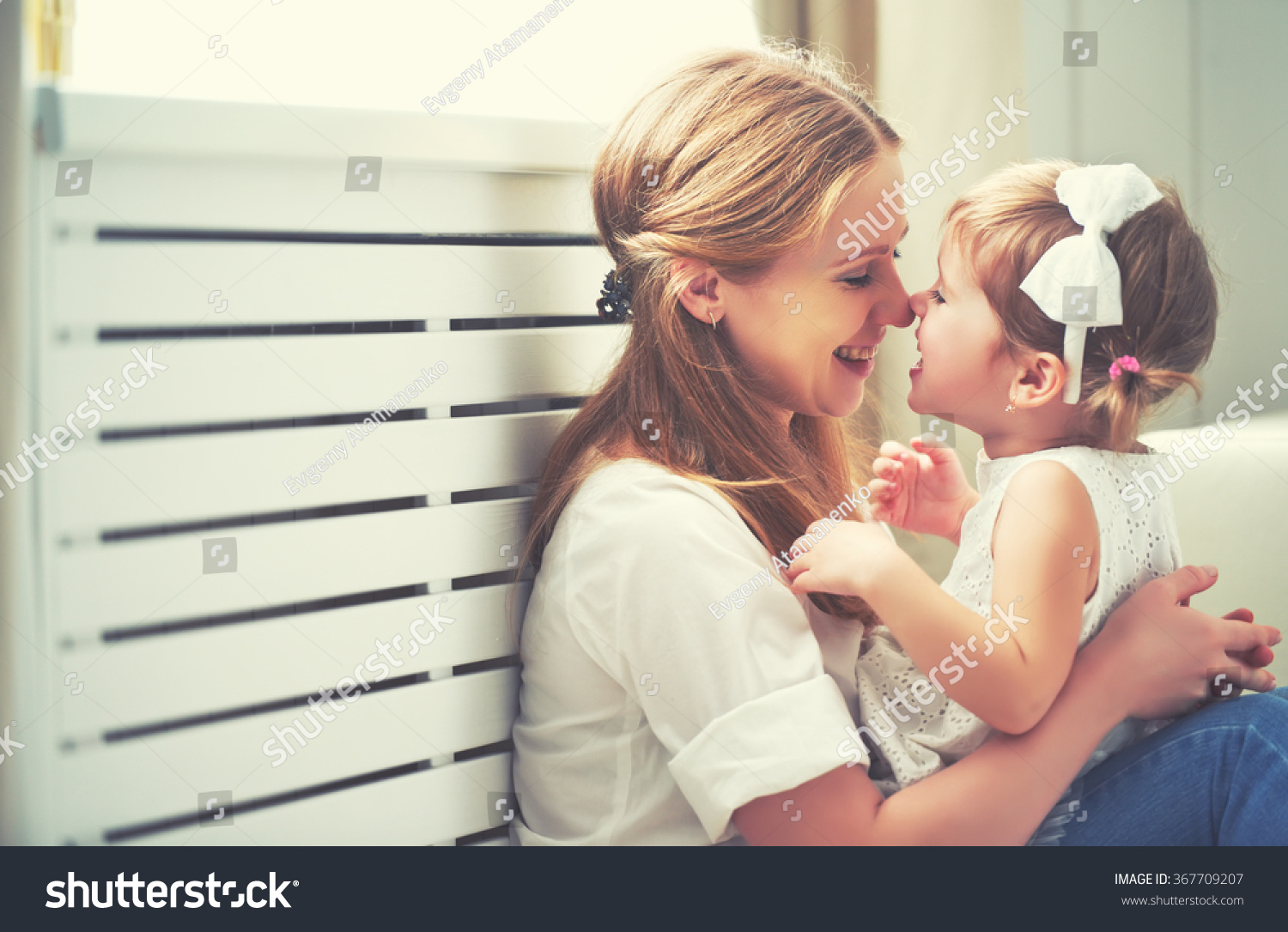 Happy loving family. mother and child girl playing, kissing and hugging #367709207