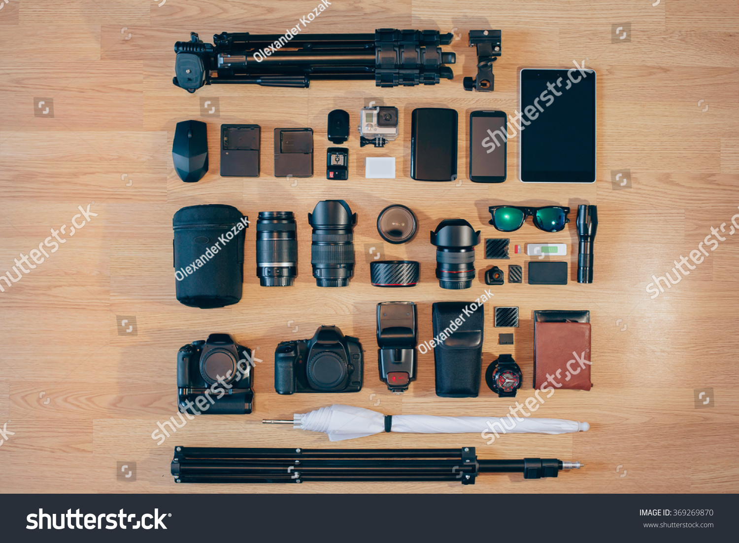 Professional photo camera kit is neatly folded on wood surface #369269870