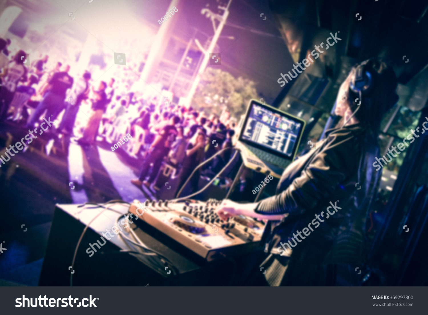 defocus blurred photo background and editable color filter of pretty DJ girl performing at exterior outdoor party #369297800